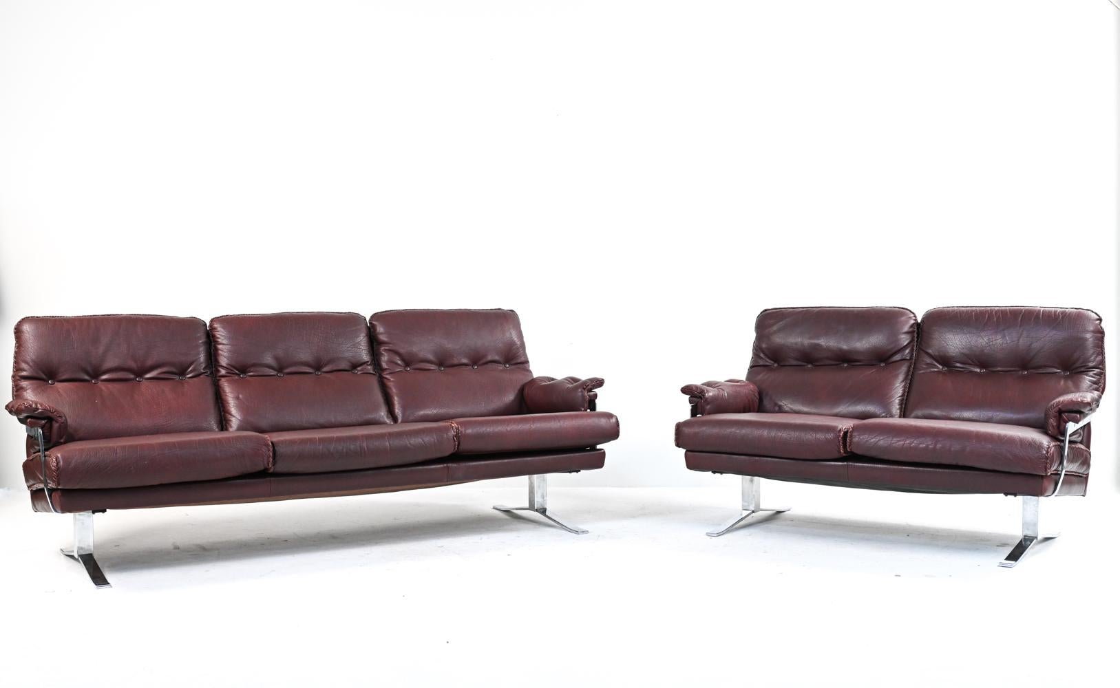 A rare (2) piece sofa suite in chocolate brown buffalo leather and chrome with fabulous whipstitch trim, designed by Arne Norell for Vatne Møbler and produced in the 1960's-1970's. Includes a loveseat and three-seater sofa.