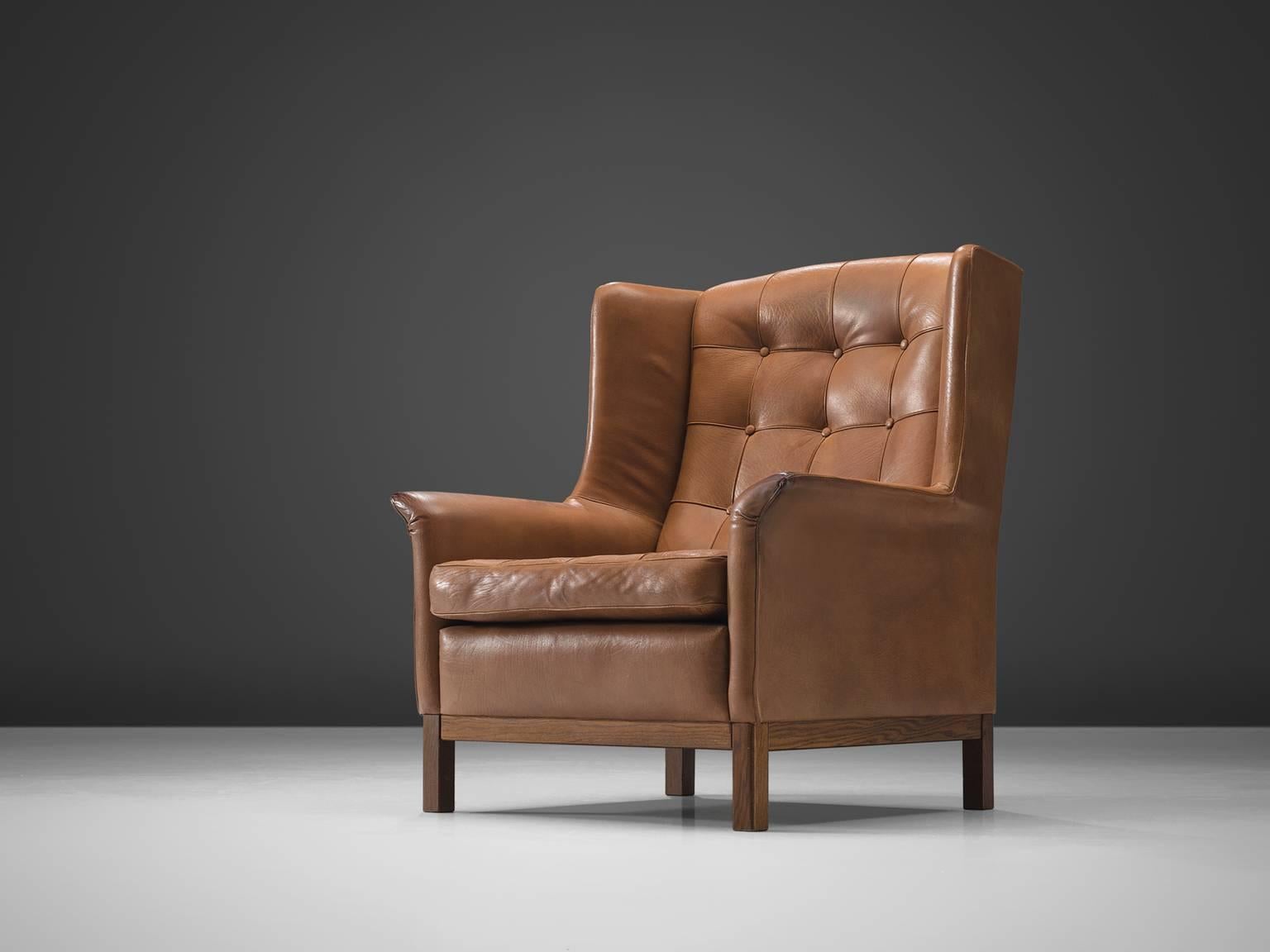 Arne Norell, high back chair, cognac leather and wood, Sweden, 1960s. 

Wonderful comfortable cognac buffalo leather easy chair by Swedish designer Arne Norell. This lounge chair comes with a very high standard of comfort, as where Norell is known