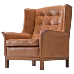 Arne Norell High Back Chair in Patinated Cognac Buffalo Leather Arne Norell High Back Chair in Patinated Cognac Buffalo Leather