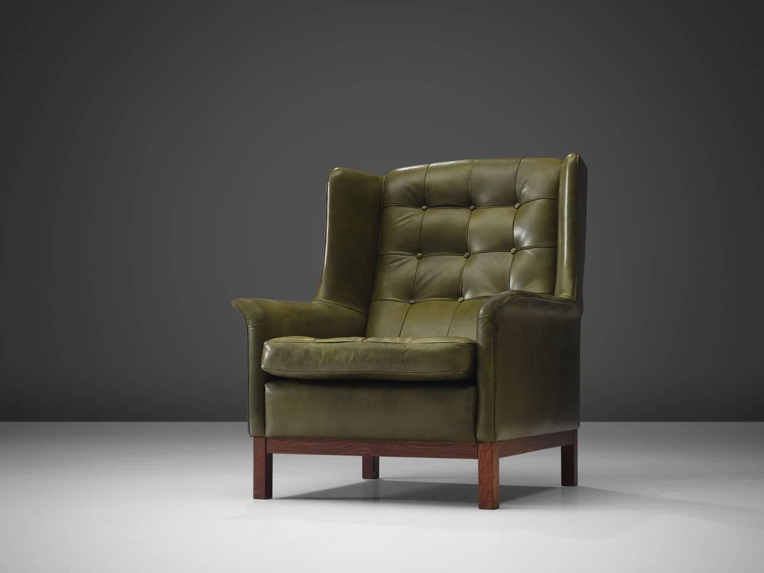 Arne Norell, high back chair, green leather and wood, Sweden, 1960s.

Wonderful comfortable green buffalo leather easy chair by Swedish designer Arne Norell. This lounge chair comes with a very high standard of comfort, as where Norell is known for.