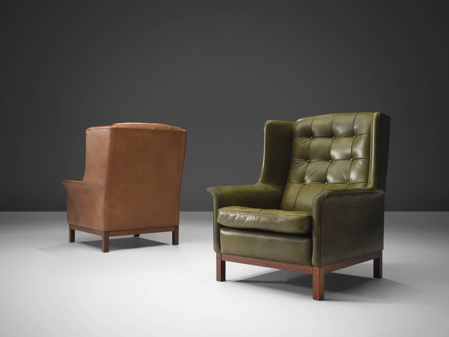 High back chairs, in leather and wood, by Arne Norell, Sweden, 1960s. 

Wonderful pair of comfortable buffalo leather easy chairs by Swedish designer Arne Norell. These lounge chairs come with a very high standard of comfort, as where Norell is