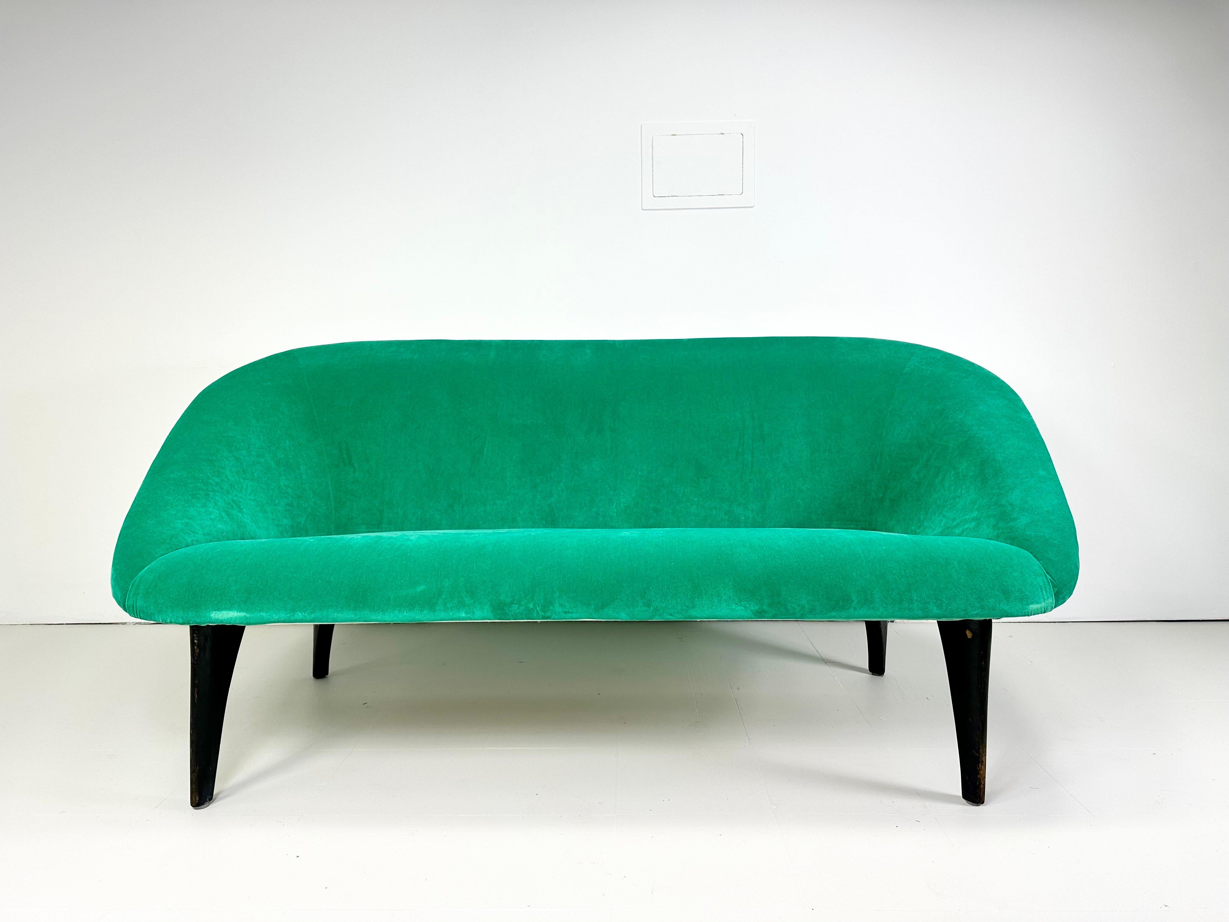 Arne Norell “Lido” Sofa for Westbergs. Sculptural Black Lacquered Legs Support this Unique 1960’s Sofa Form. More recent micro suede upholstery with nail head details outlining the back legs. Sweden. Unmarked