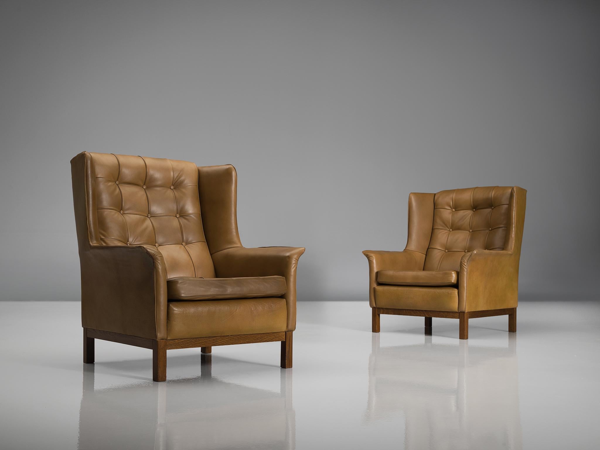 Arne Norell, pair of highback chairs, in leather and wood, Sweden, 1960s.

Wonderful pair of comfortable buffalo leather easy chairs by Swedish designer Arne Norell. These lounge chairs come with a very high standard of comfort, something that