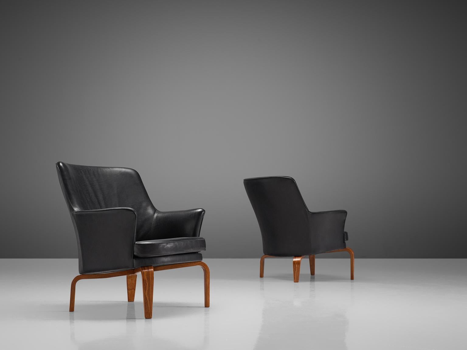Arne Norell for Norell mobilier, 'Pilot T184' armchairs with leather and stained beech, Sweden, 1970s. 

This set of high back chairs are slightly curved and have a high headrest. They are upholstered entirely with very high quality aniline black