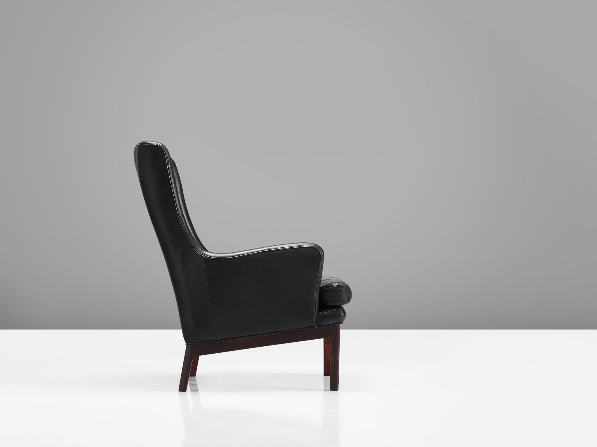 Arne Norell for Norell mobilier, leather and stained beech, Sweden, 1970s. 

This high back chair features a small wingback and curved armrests. The frame is made out of stained beech and the two front legs are slightly higher than the two back