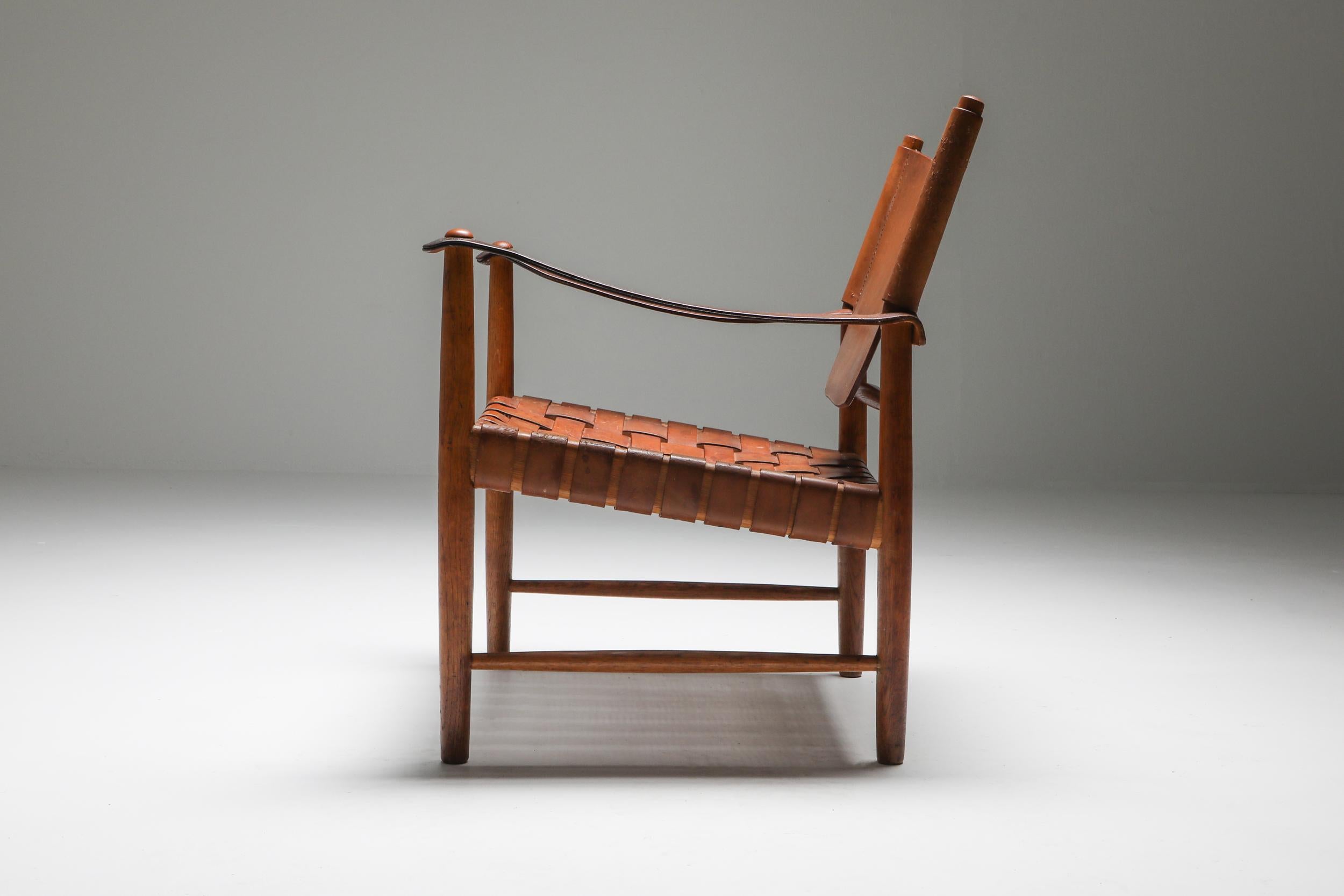 Sirocco Safari chair by Arne Norrél, Sweden, 1960s.

Designed by Swedish architect Arne Norell in circa 1962 and made by his own company 'Norell Möbel AB' in Sweden. Frame in solid wood, armrests and backrest in thick brown leather and seating in