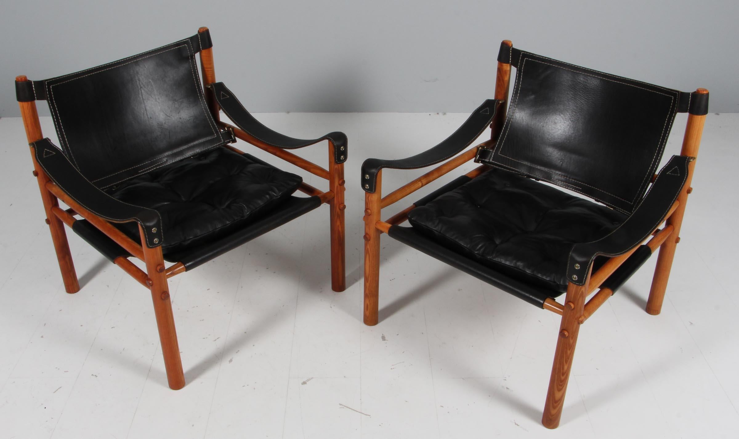 Set of Arne Norell safari chairs. Original upholstered foam cushions with black leather.

Frame of ash.

Model Scirocco, made by Norell.