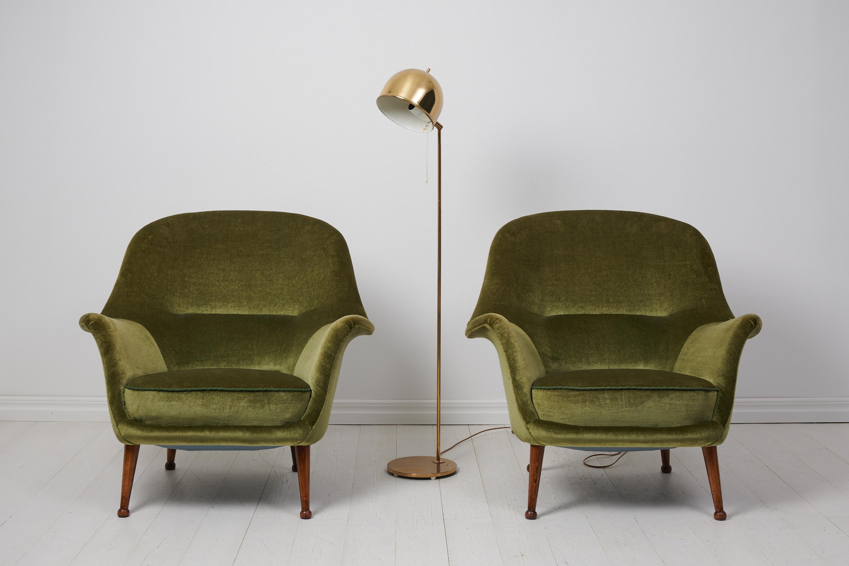 Arne Norell “Divina” armchairs by Westbergs Möbler AB, Tranås in Sweden. The chairs are a genuine pair from the 1960s and radiate the Scandinavian modern style. The chairs have legs in dark wood with finishes on the feet in the shape of balls, they