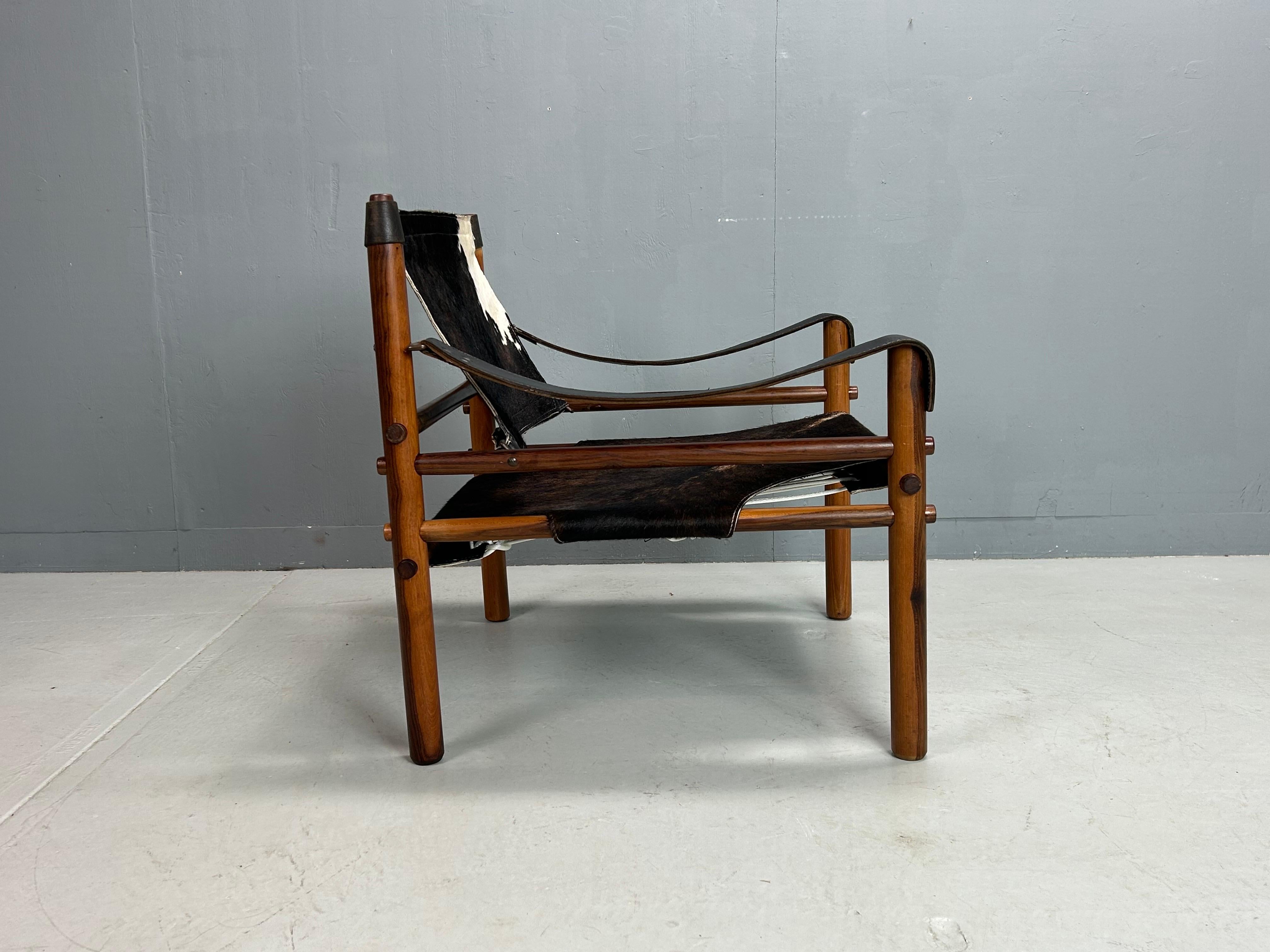 Pair of iconic Sirocco safari chairs by Arne Norell, crafted in the 1970s by Arne Norell AB in Aneby, Sweden. Featuring original leather and solid wood frames, this chair is reupholstered in new cowhide leather and is in  very good condition,
