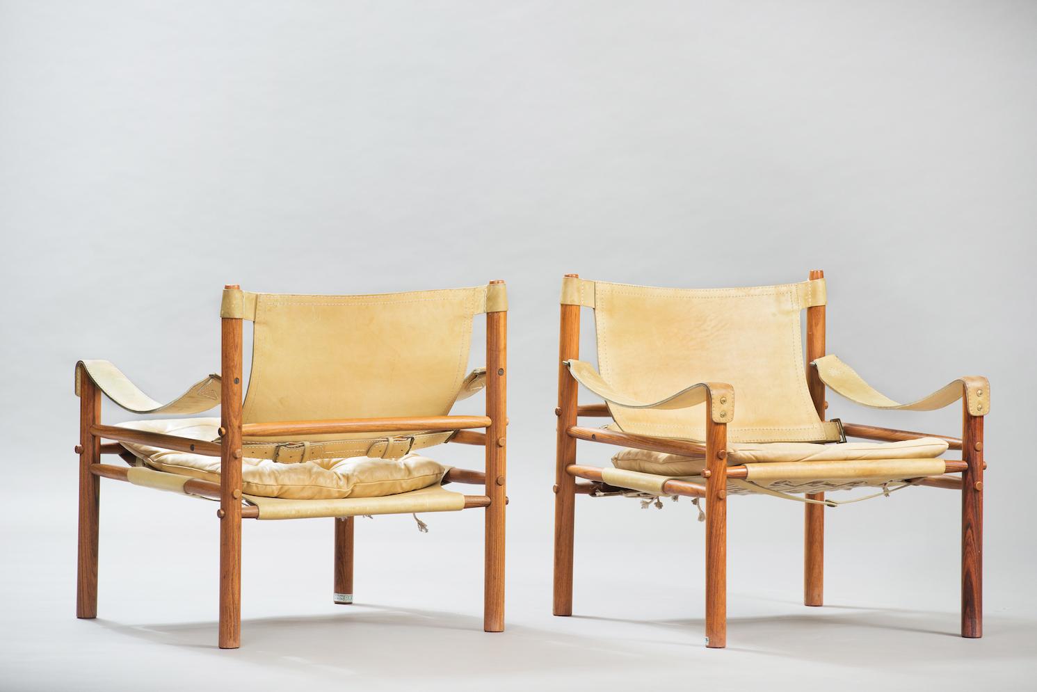 One pair rosewood and green leather Safari easy chairs, “Sirocco” model.