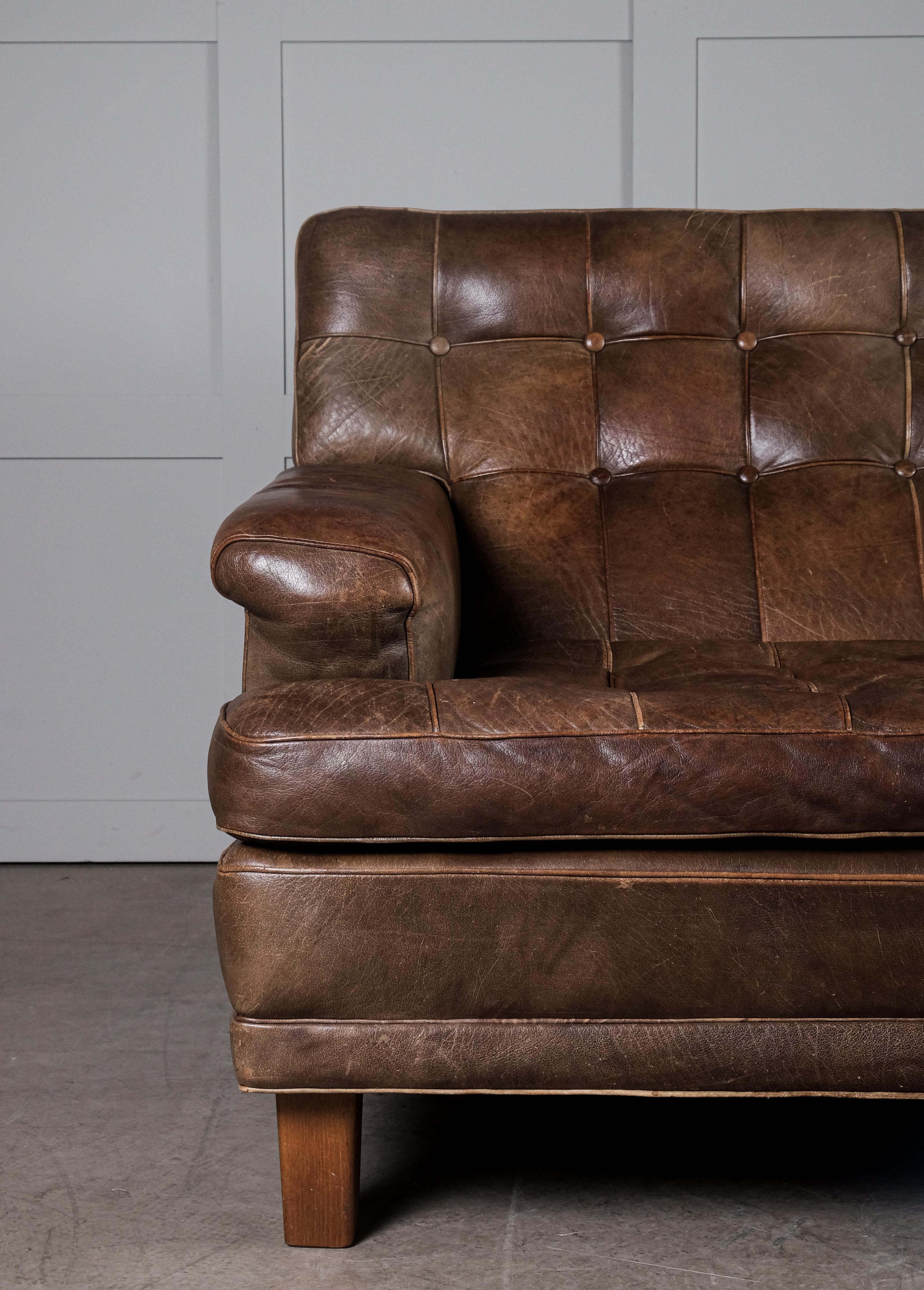 Designed by Arne Norell and produced by Arne Norell Möbel AB, Sweden, 1960s.
All original, dark stained beech legs and dark brown buffalo leather. Great vintage condition with small signs of usage and patina.
 