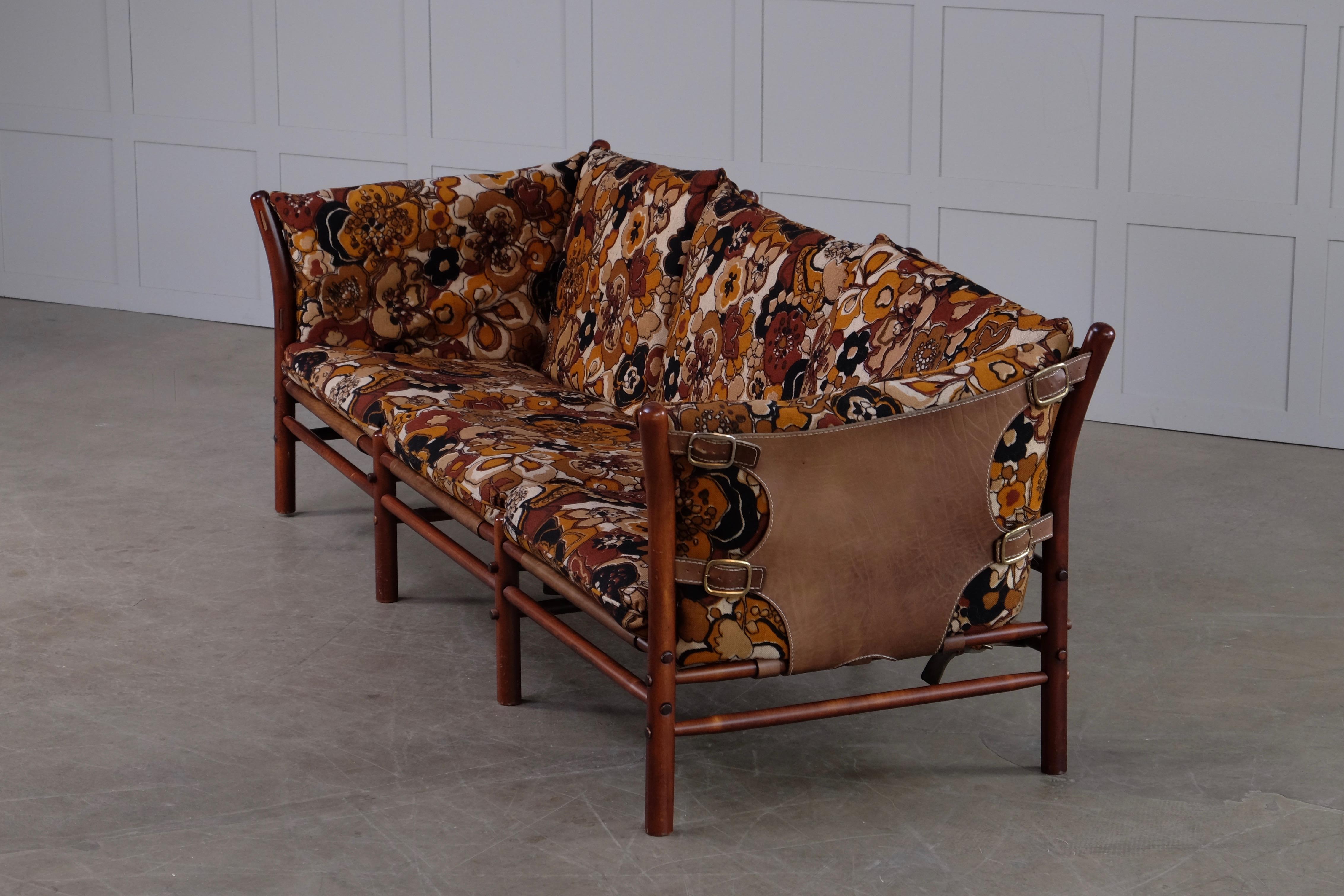 Three-seat. Original fabric, brown leather, brass, stained beech.
Design by Arne Norell, produced by Arne Norell Möbel, Sweden.

      