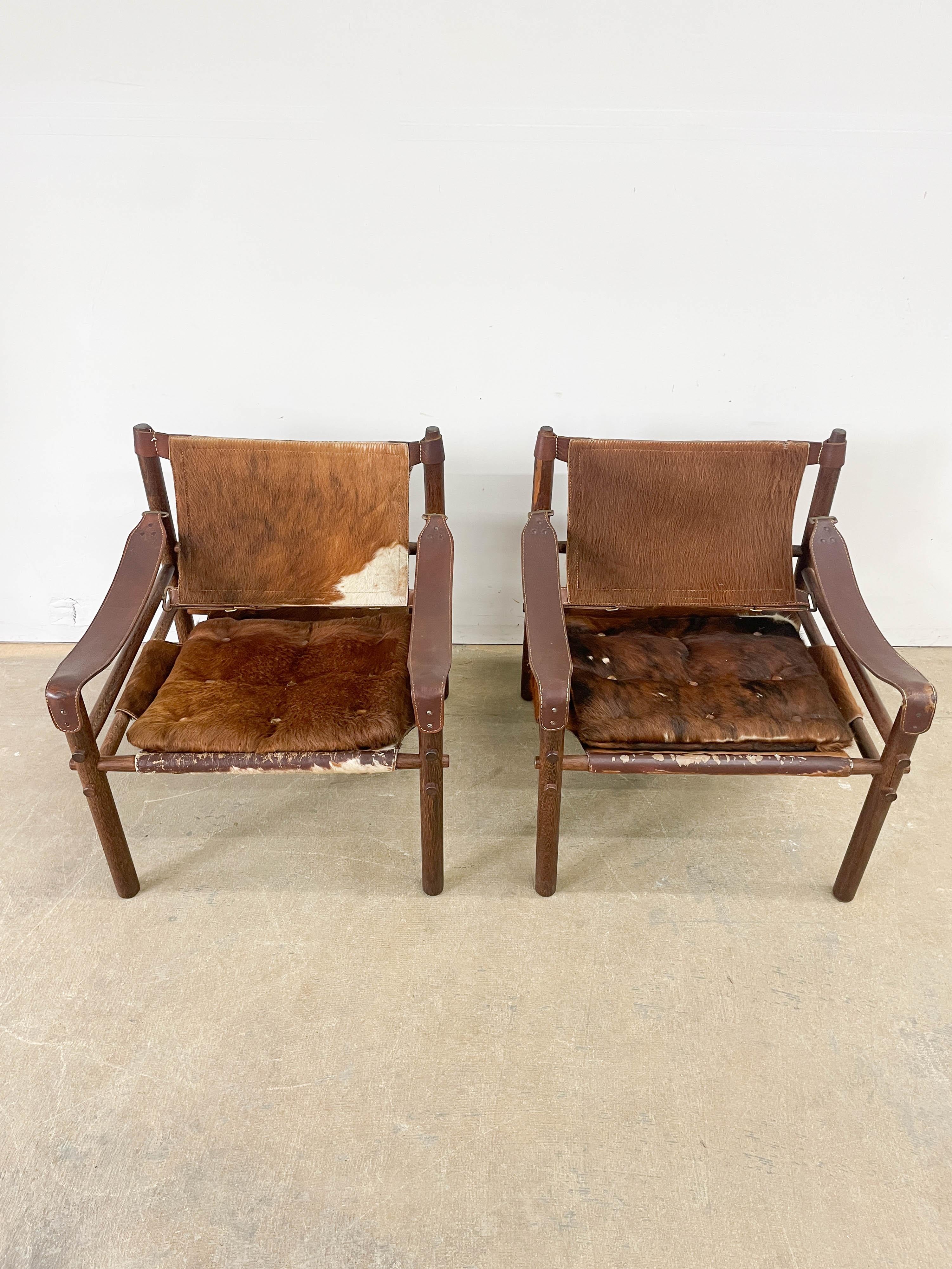 Rare Wenge wood and original calfskin sling Sirocco model safari chairs designed by Arne Norell in 1964 and made by his company Norell in the 1960s. Simple through dowel construction and beautiful materials combine to make this luxurious version of