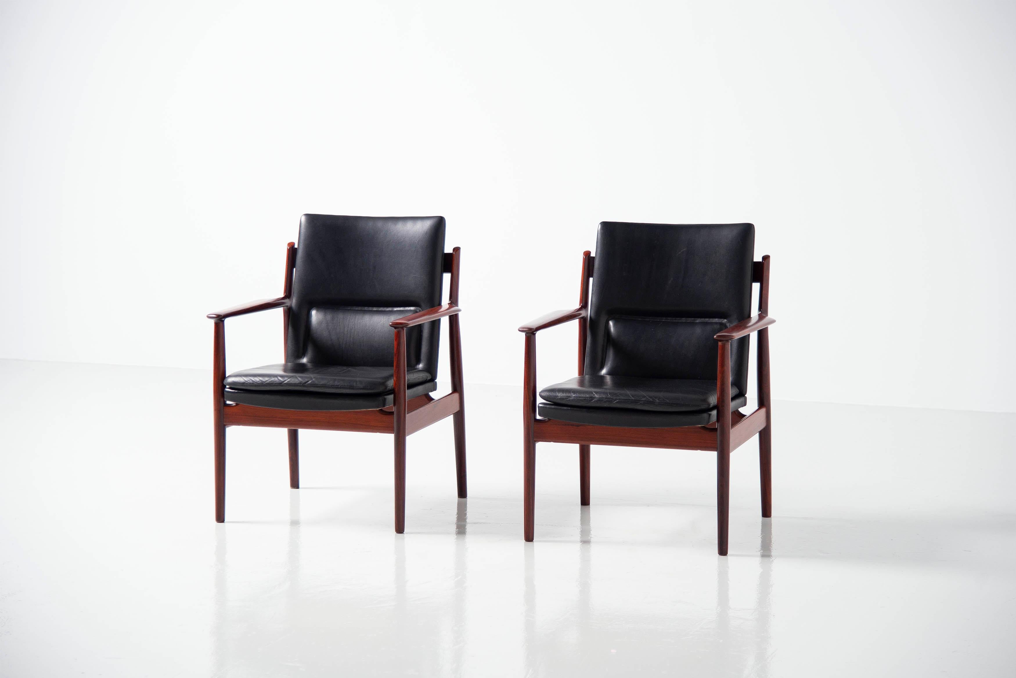 Set of 431 arm chairs designed by Arne Vodder and manufactured by Sibast Mobler, Denmark 1960. The chairs have a solid rosewood frame and black leather upholstery. These chairs are highly refined with beautiful grained rosewood and woodworking into