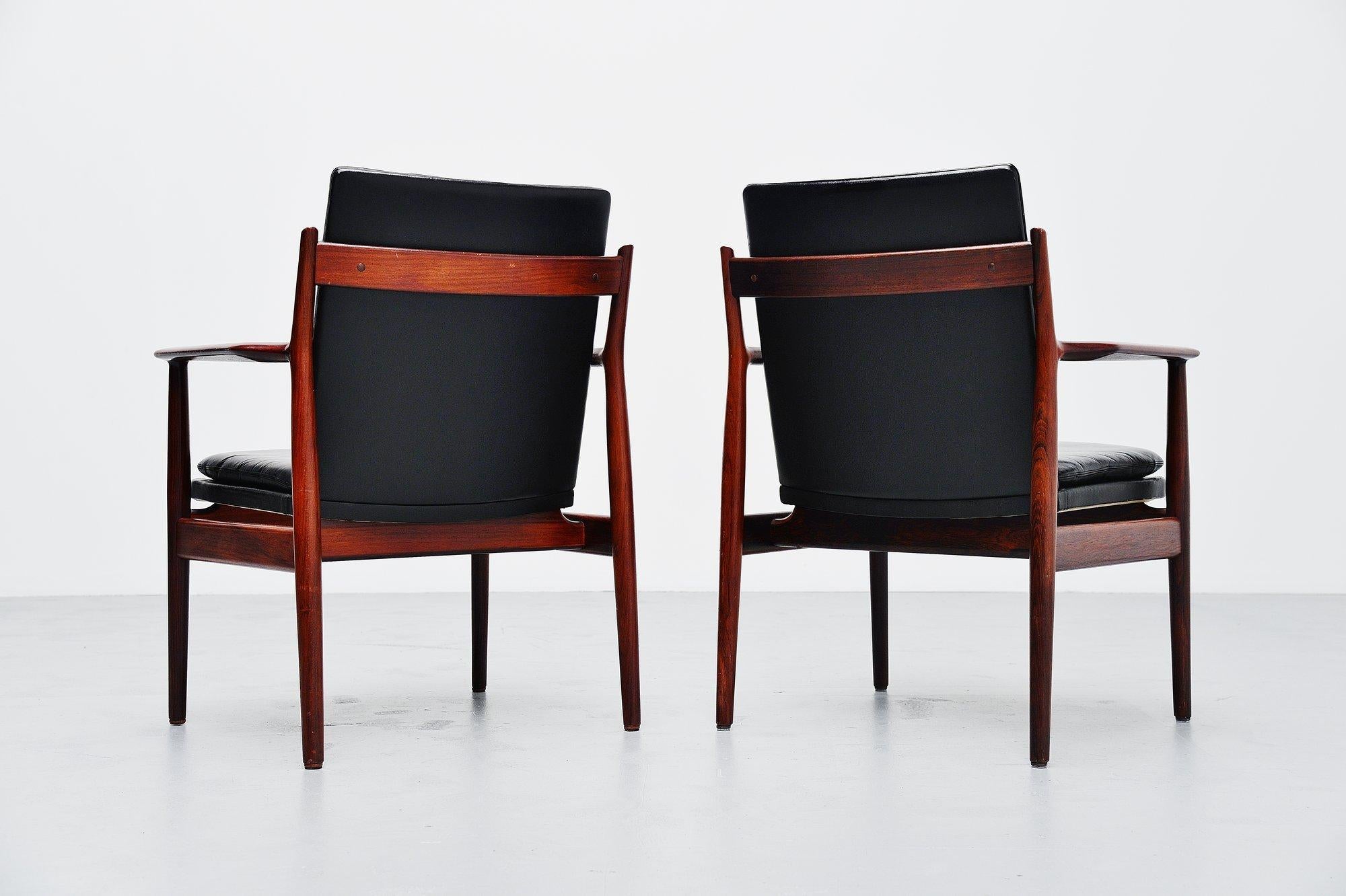 Nice pair of 431 armchairs designed by Arne Vodder and manufactured by Sibast Mobler, Denmark 1960. The chairs have a solid rosewood frame and black leather upholstery. The upholstery is still original and in very good condition. One chair looks