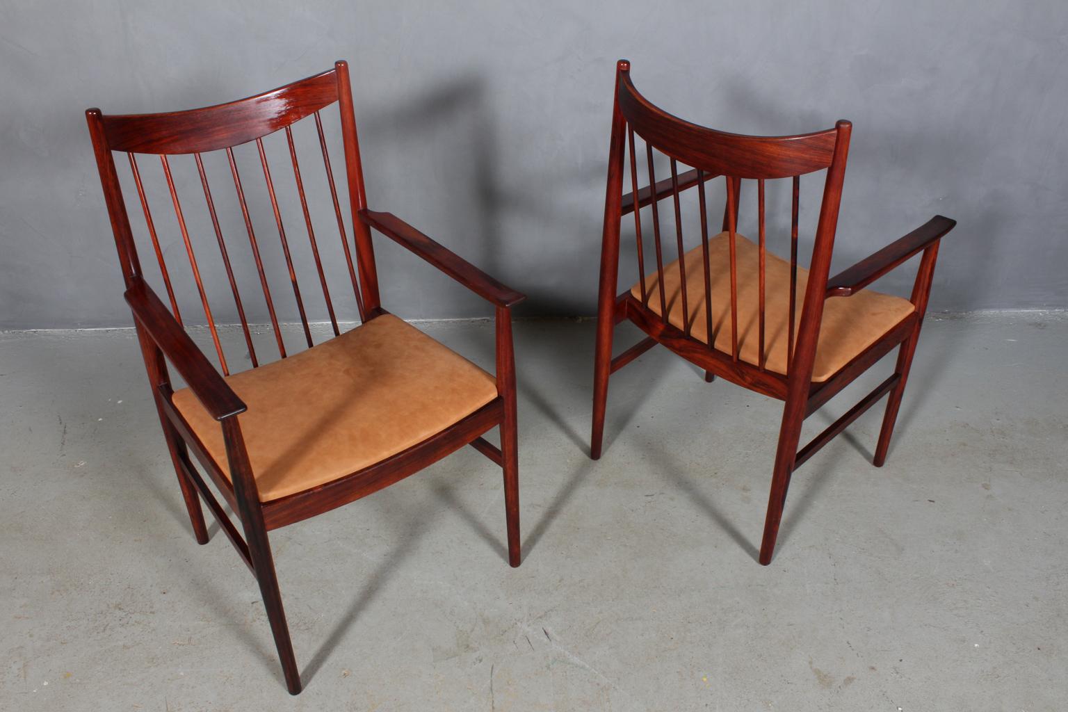 Two Arne Vodder armchairs, new upholstered with cognac Dunes aniline leather from Arne Sørensen.

Frame in partly solid rosewood.

Model 422, made by Sibast.