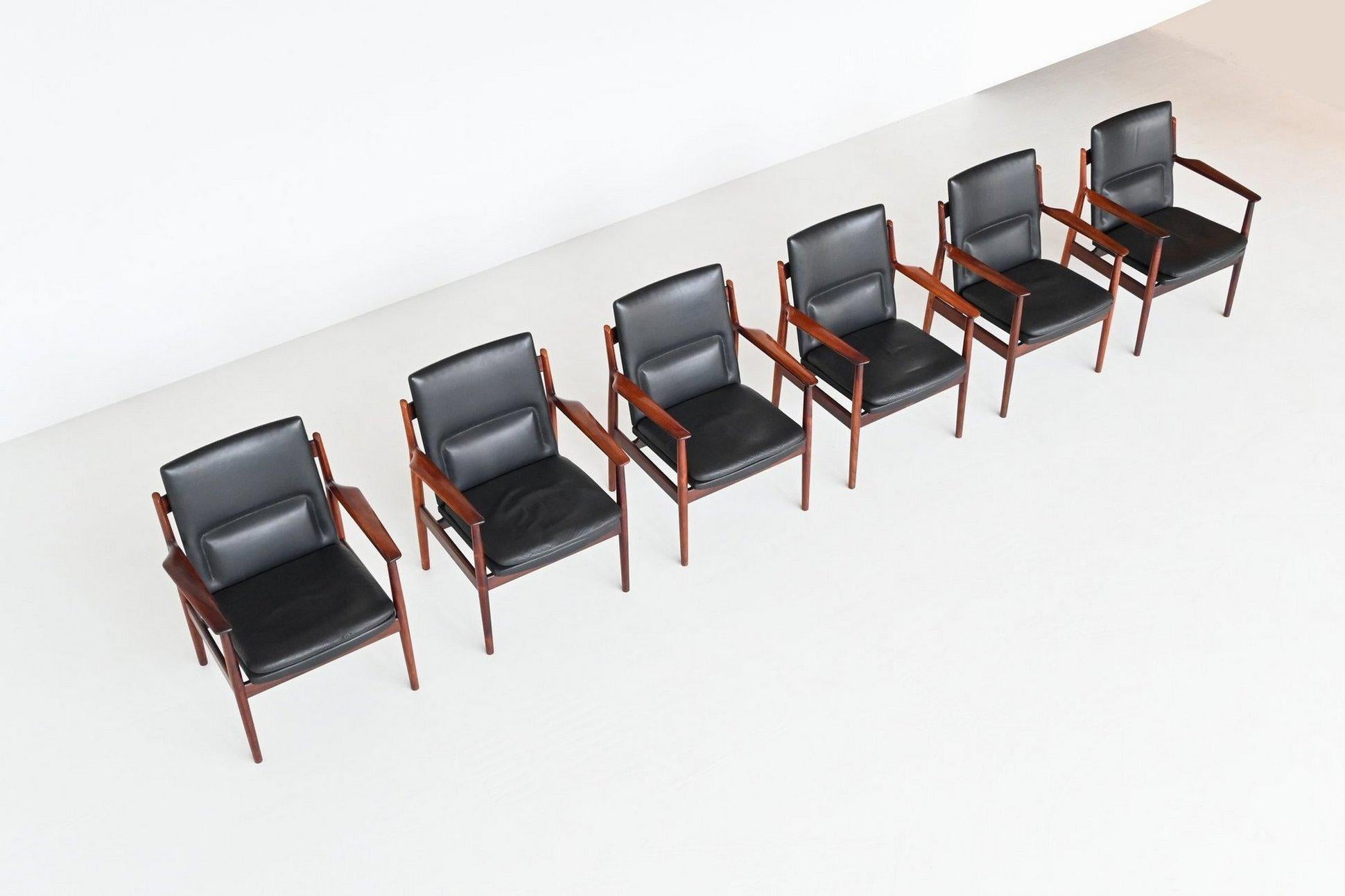 Beautiful and rare set of six armchairs model “431” designed by Arne Vodder for Sibast Furniture, Denmark 1960. This Danish design exclusive chair has sculptural rosewood armrests. The solid rosewood frame and original patinated black leather