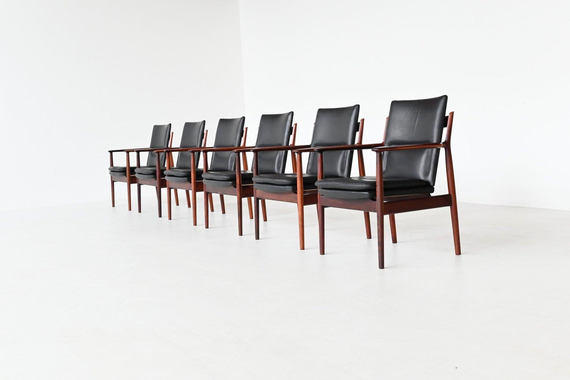 Beautiful and rare set of six armchairs model 432 designed by Arne Vodder for Sibast Furniture, Denmark 1960. This Danish design exclusive chair has sculptural rosewood armrests. The solid rosewood frame and original patinated black leather seating