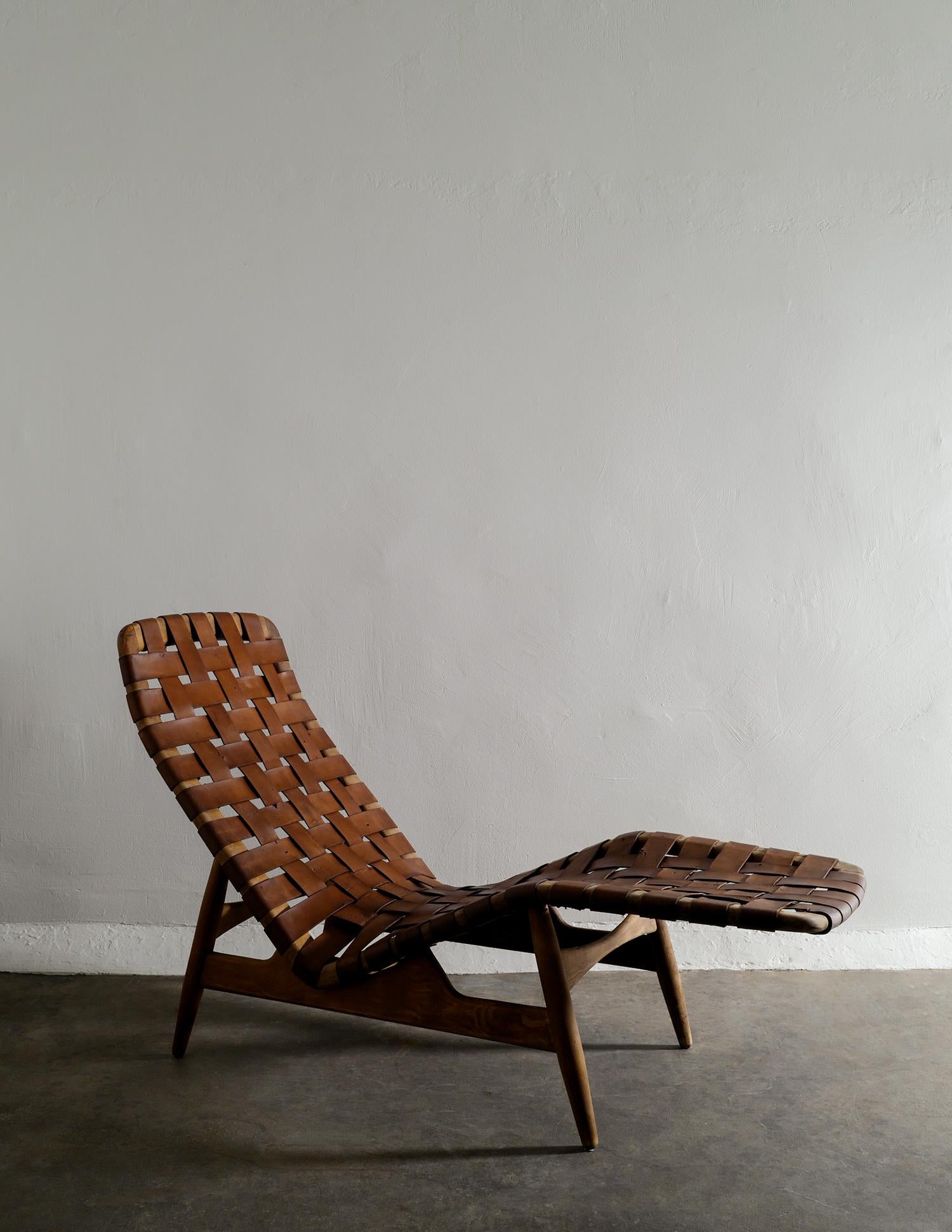 Very rare chaise lounge chair in ash and brown leather designed by Arne Vodder in the 1950s produced by Bovirke, Denmark. In good vintage condition with signs and patina from age and use. 

Dimensions: H: 94 cm W: 145 cm D: 58 cm SH: 33 cm.
