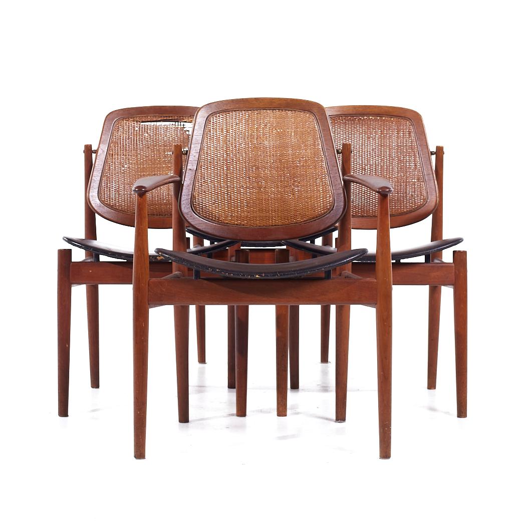 Arne Vodder for Charles France & Eric Daverkosen Mid Century Danish Teak and Cane Dining Chairs - Set of 4

Each armless chair measures: 20.25 wide x 21 deep x 33.75 high, with a seat height of 17.25 inches
Each captains chair measures: 25 wide x 21