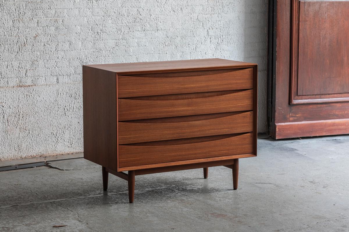 Chest of drawers designed by Arne Vodder and produced by Sibast in Denmark in the 1960’s. It is made of teak wood. It contains 3 beautifully sculpted drawers. The second drawer is missing a small chip of veneer on the left hand side, for the rest in