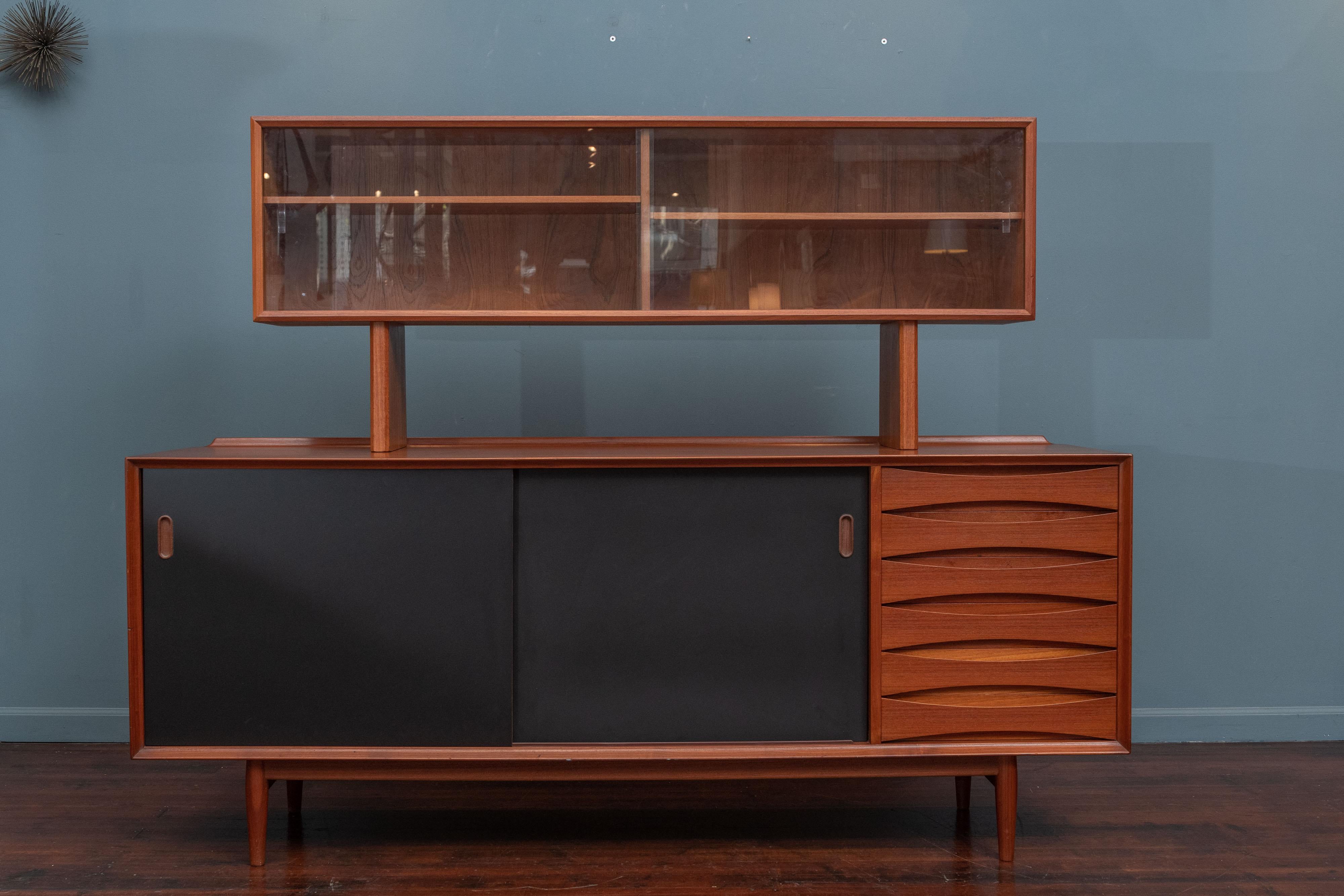 Arne Vodder design credenza Model 29, for Sibast. The doors are reversible with newly painted matte black lacquer on one side and teak on the other. 
The credenza has six drawers with three adjustable shelves. The beautiful bowtie front drawers are