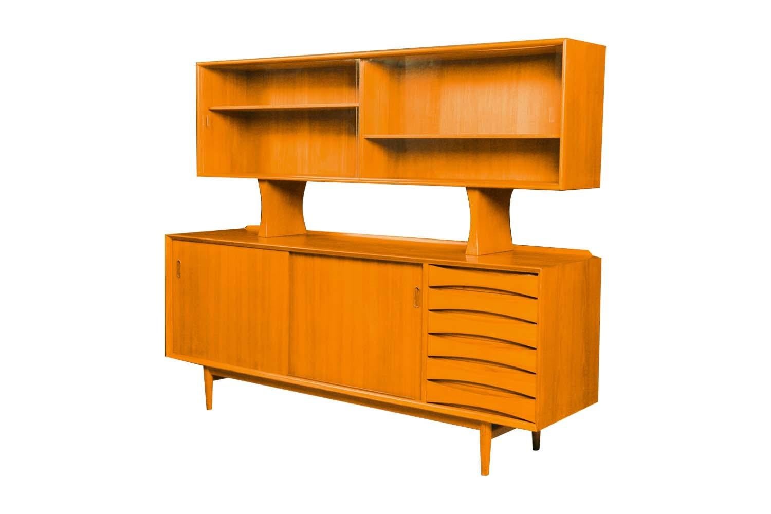Exceptional Mid Century teak two-piece, rare, floating hutch, reversible sliding door, credenza model OS-29 designed by Arne Vodder for Sibast Mobler made in Denmark, circa 1960’s. World famous for winning the Gold Medal at the 1958 Milan Triennale