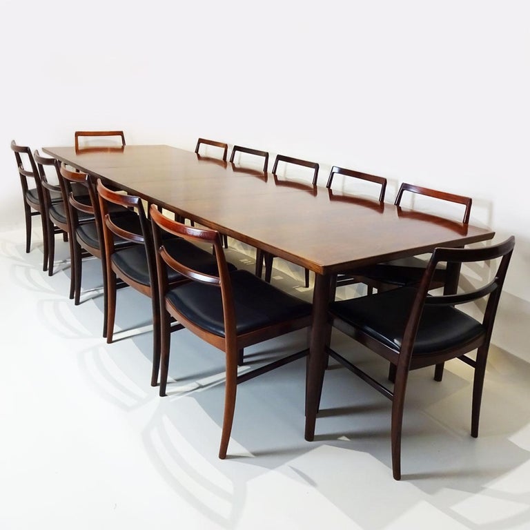 An extremely rare and complete midcentury dining set incorporating a 3 metre extending rosewood model 201 dining table and 12 solid rosewood and black leather model 430 dining chairs by Arne Vodder for Sibast Furniture.

I literally don’t have