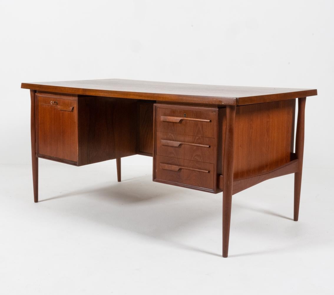 A rare and exceptional Danish midcentury double sided executive desk designed by Arne Vodder, c. 1960s. After studying under Finn Juhl at the Royal Danish Academy of fine Arts in Copenhagen and graduating in 1947, Vodder's career as a furniture