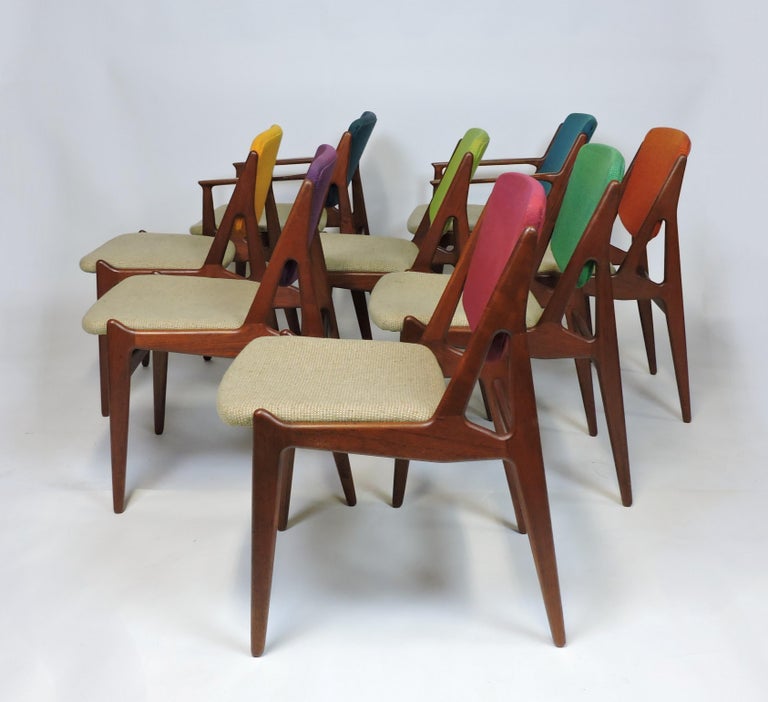 Beautiful set of 8 Ella dining chairs designed by Arne Vodder and made in Denmark by Vamo Sonderborg. The set consists of 6 side chairs and 2 arm chairs, all of which are made of sculpted solid teak and have backs that tilt for comfort. The wood has