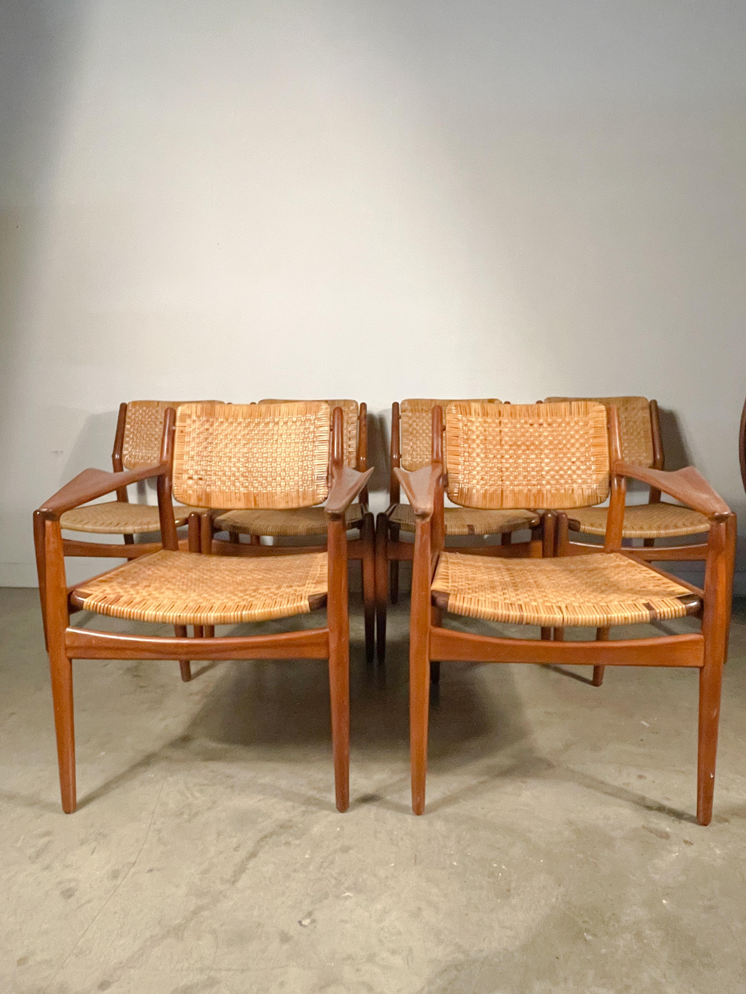 A rare set of teak framed chairs with woven cane seats and backs designed by Arne Vodder and made by Sibast of Denmark in the 1950s.
 
This set includes four side chairs and two model 51a arm chairs, the latter of which are particularly sought