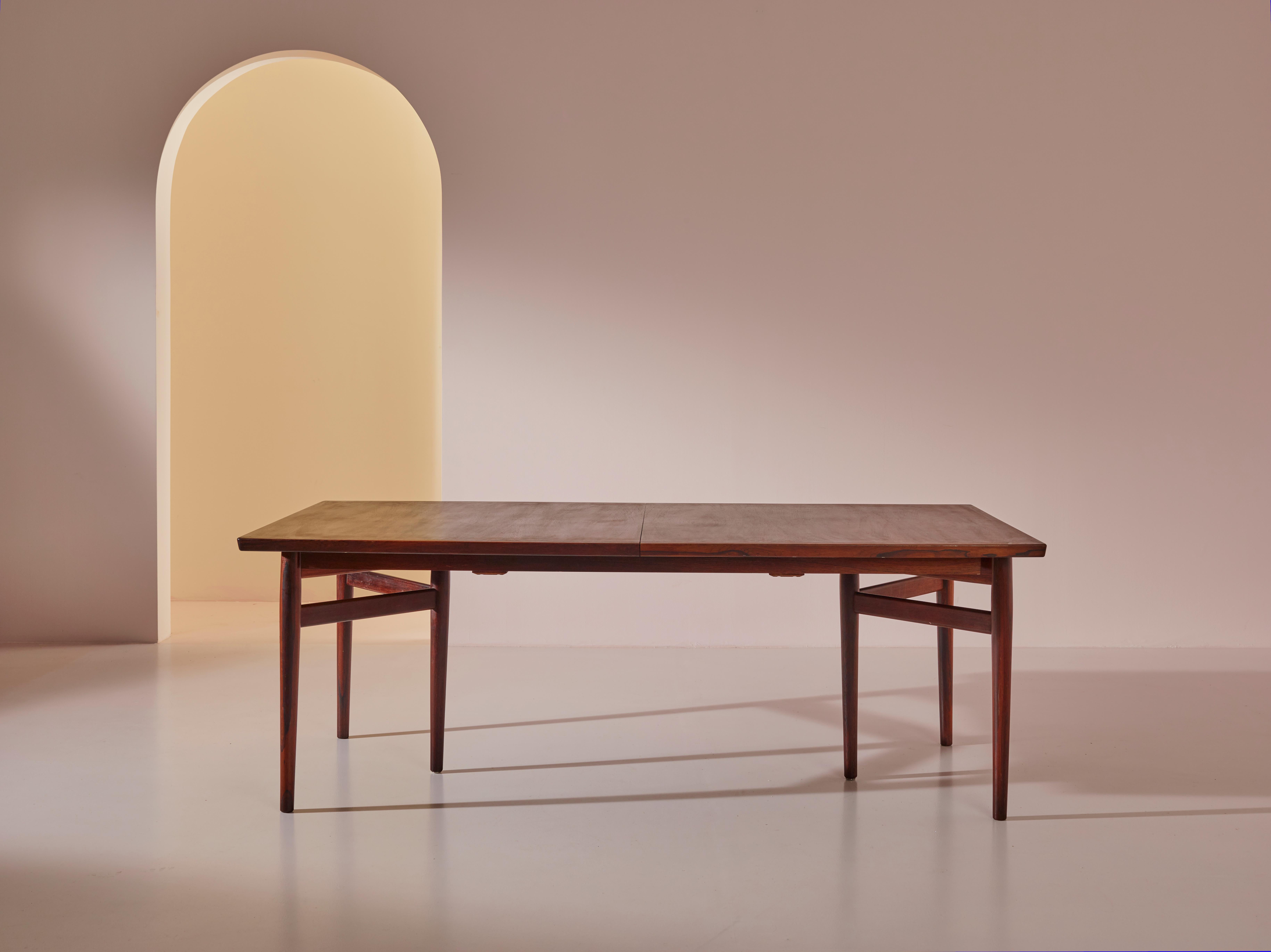 An elegant dining table, Model 201 by Arne Vodder for Sibast Møbelfabrik, Denmark, dating back to the 1960s. This refined table showcases a rectangular walnut top, supported by distinctive triangular bases. Meticulously restored and refinished, the