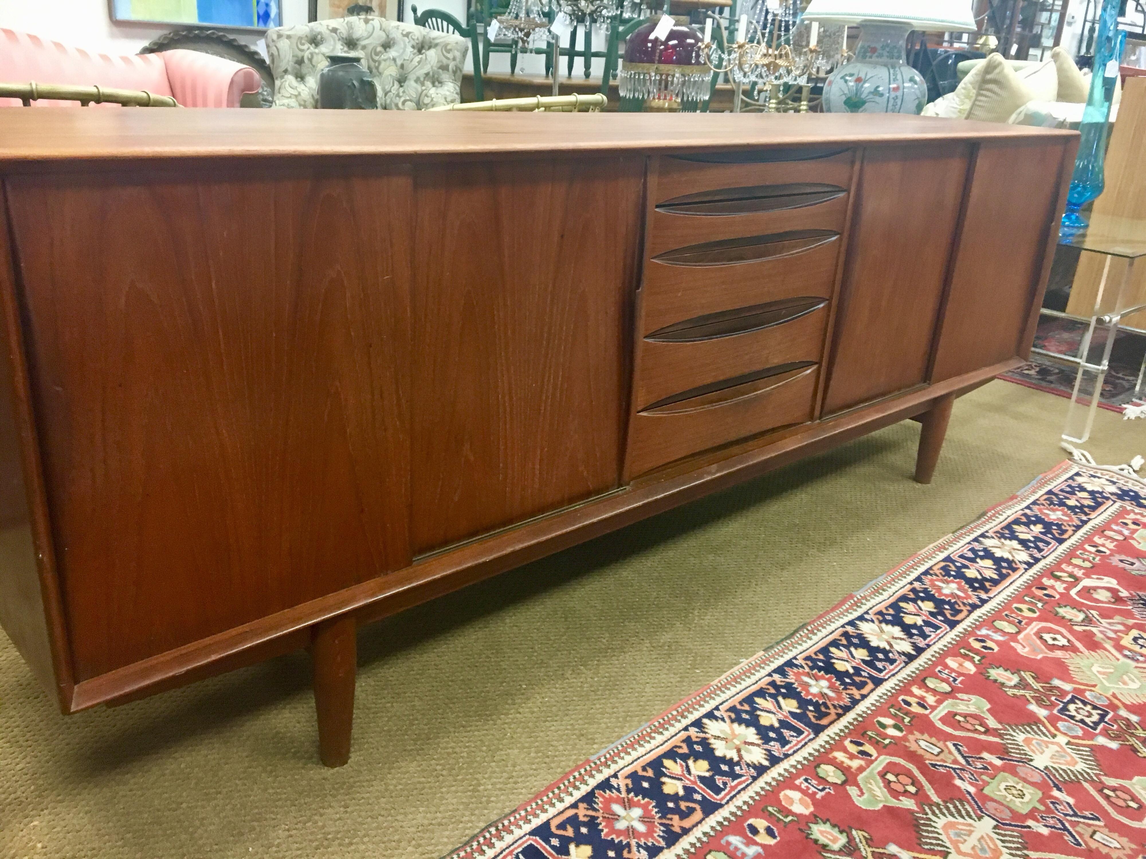 Danish modern teak buffet bar is exquisite throughout and is attributed to Arne Vodder for Dyrlund. Featuring a center bank of bow-tie shaped drawers, with all hardwood construction and dovetail joins (the top two are slimmer and felt lined). One