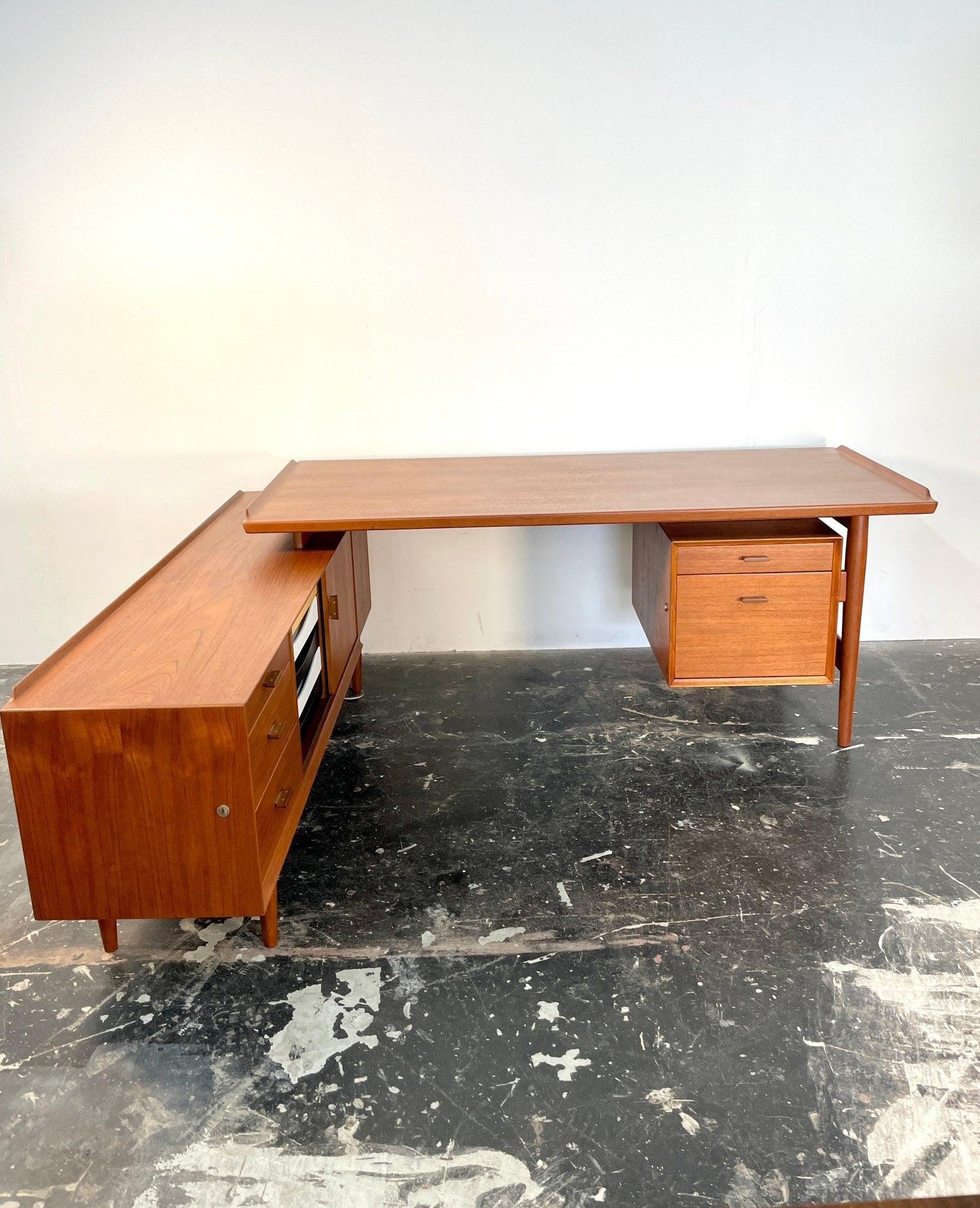 Rare Executive writing desk designed by Arne Vodder and produced by Sibast furniture in Denmark around 1960. This large L-shaped desk is made of solid teak and high quality old-growth teak veneer and it is finished with on all of its many sides. Key