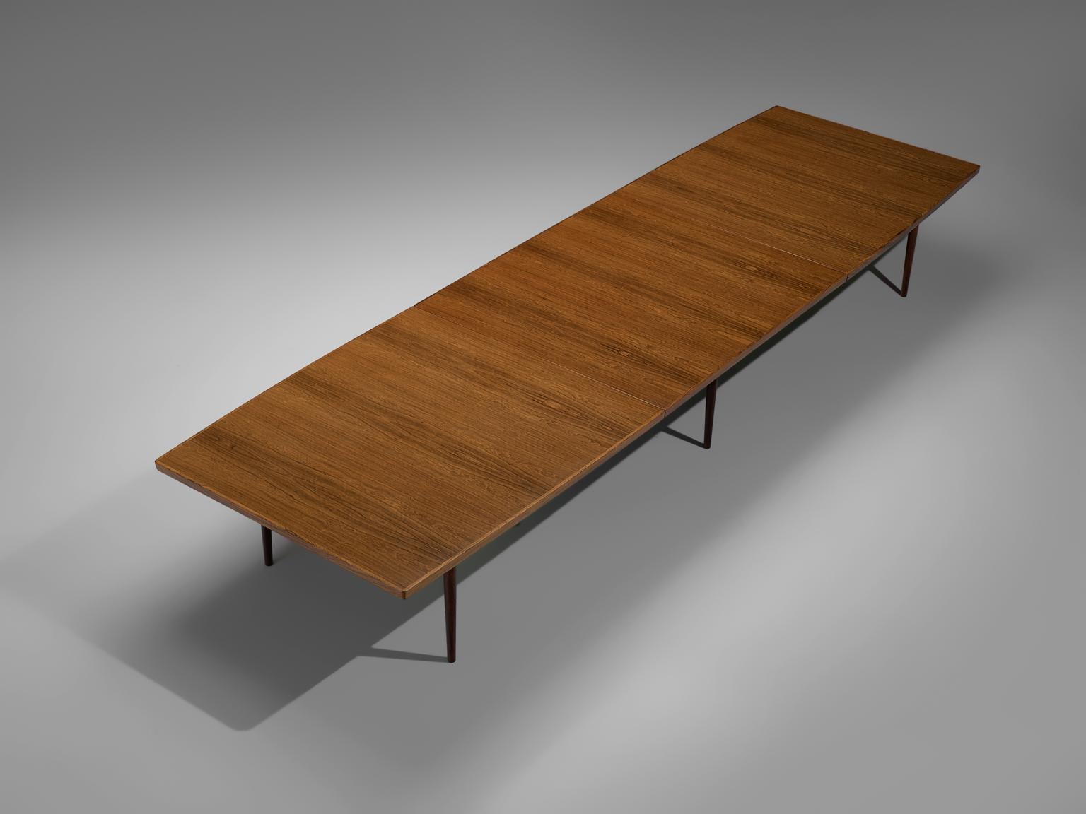 Large conference table, rosewood, Denmark, 1960s

Extremely large dining table of nearly five meters by Danish Arne Vodder. The rectangular shaped top is supported by eight straight, tapered legs. Due to the great size the grain of the rosewood is