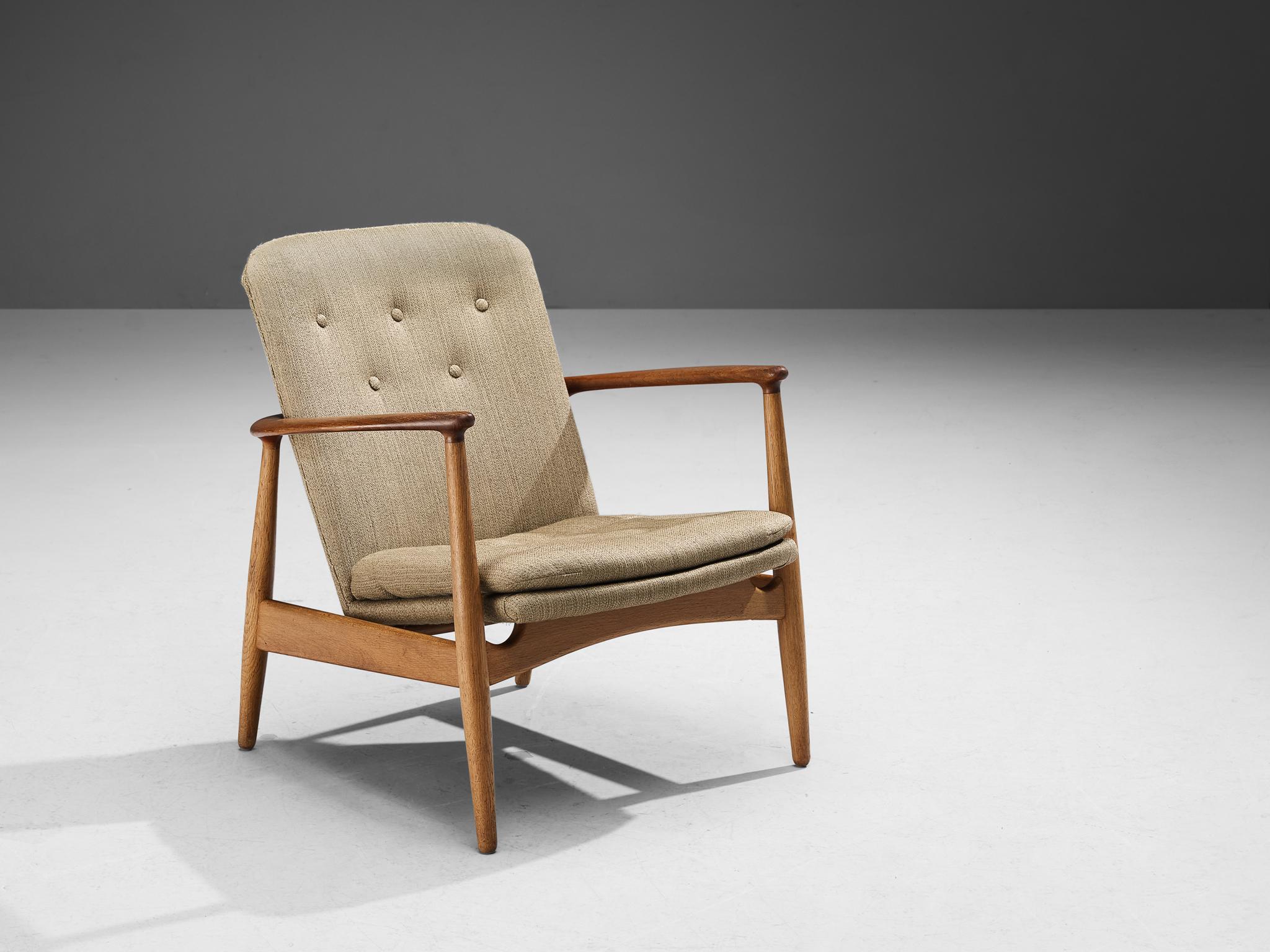Arne Vodder for Bovirke, lounge chair, model 'BO 90', Denmark, 1952

This easy chair is defined by its crescent-shaped armrests that run all the way behind the back, beautifully surrounding the backrest in an organic manner. The constructive carved