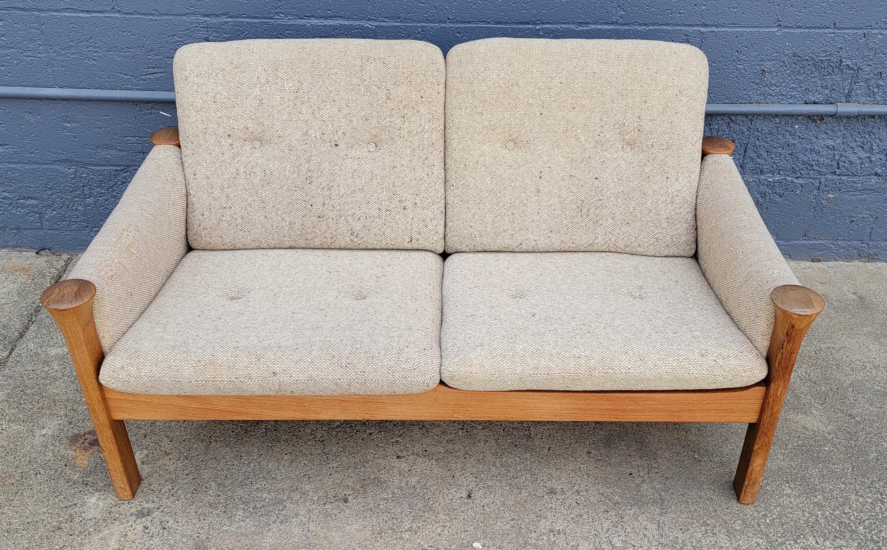 Two seat sofa designed by Arne Vodder for Cado. Made in Denmark 1970's. Substantial, solid teak frame. Reversible seat cushions. Retains 