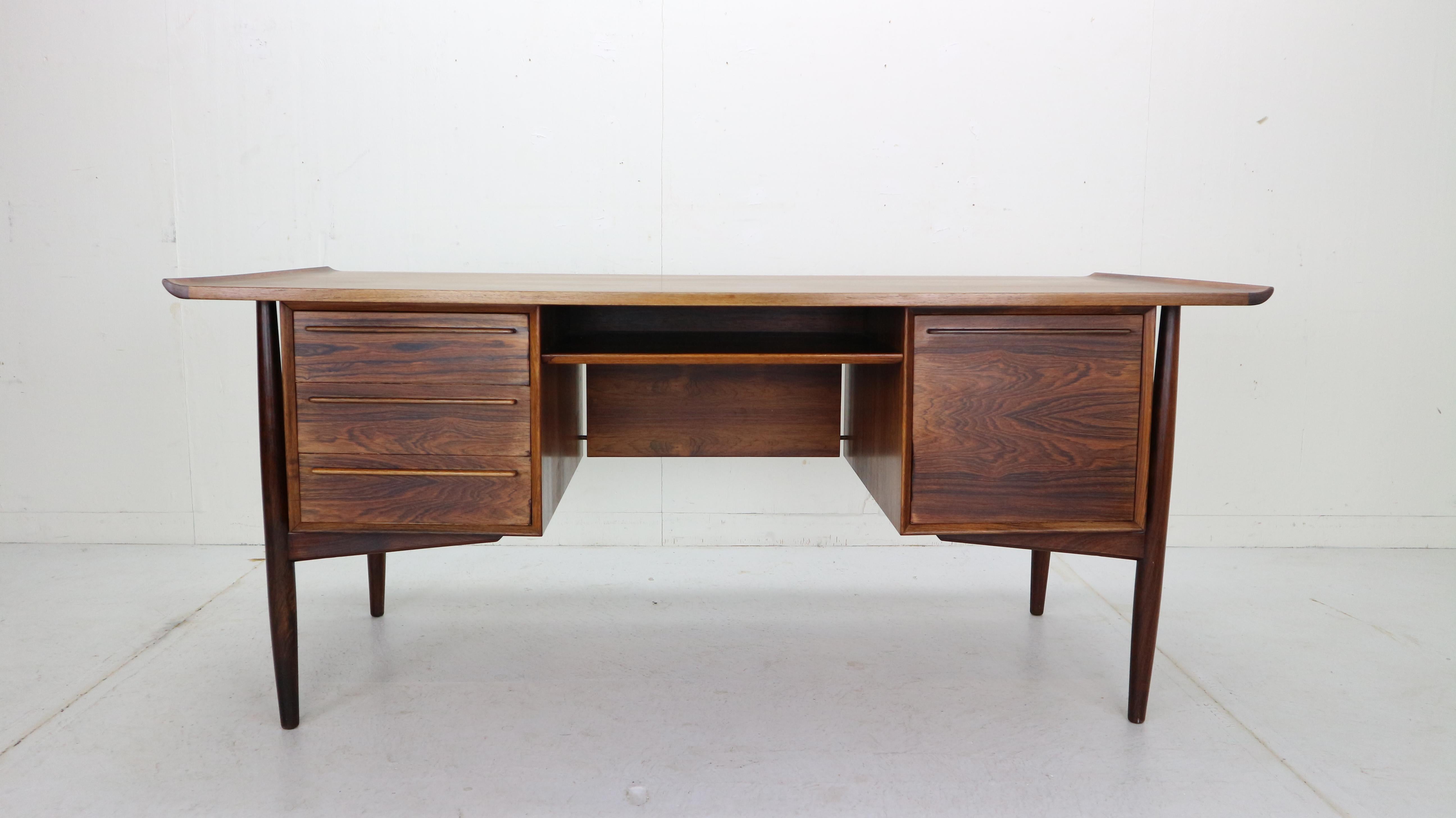 Magnificent rosewood desk designed by Arne Vodder for H. P. Hansen in 1960s period, Denmark.
The Danish architect and designer Arne Vodder was recognized as one of the most important Danish architects / designer of the mid-20th century.
This desk