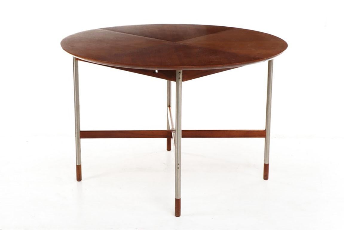 Fantastic small dining table attributed to Arne Vodder for Sibast, Denmark. Walnut top, X-form stretchers and sabots. Brushed stainless steel legs make for an unusual and eye-catching dining table for a breakfast nook or small dining room. We have