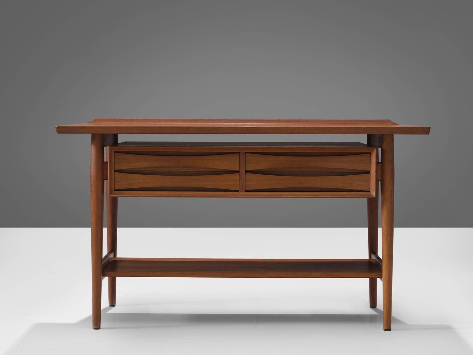 Arne Vodder for Sibast Møbler, console table, teak, Denmark, 1960s.

This console table in teak is designed by the Danish designer Arne Vodder. The typical refined Vodder details can be found on this piece such as the characteristic drawers with
