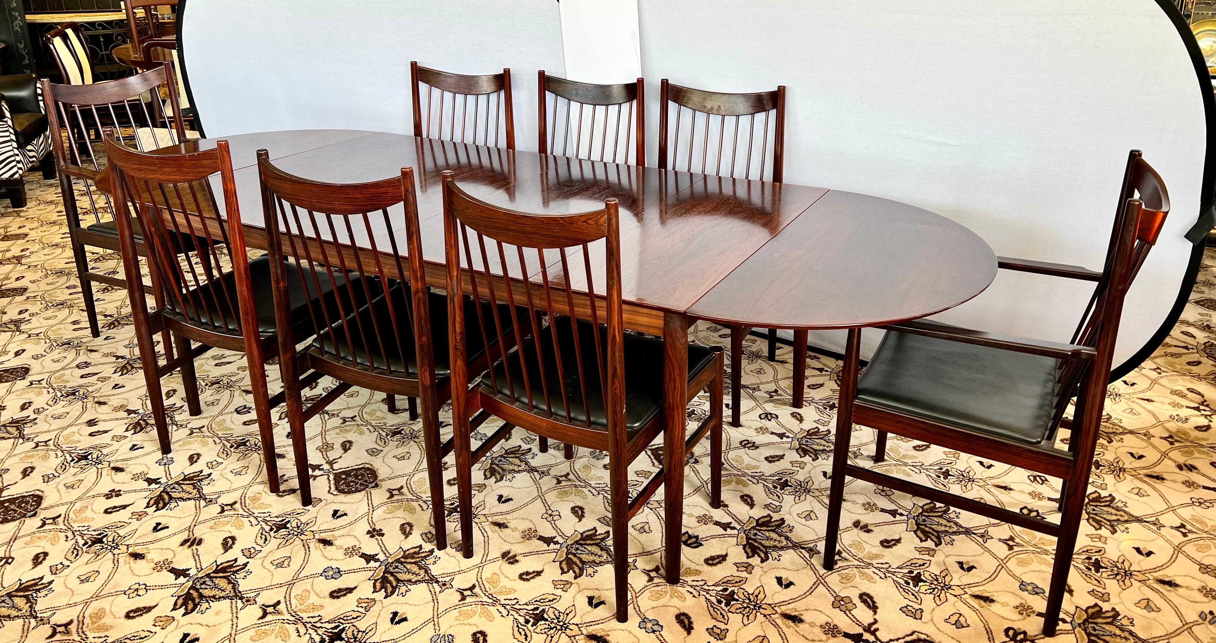 Magnificent matching dining room set that features eight coveted #422 chairs that have black leather seats and rosewood frames. The table is expandable up to 112