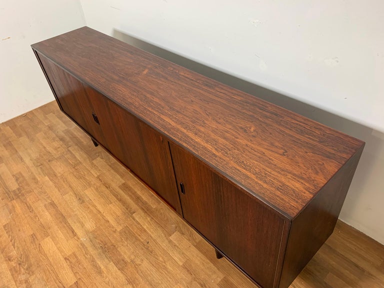 Danish rosewood credenza with tambour doors designed by Arne Vodder for Sibast, ca. 1960s. Ample adjustable shelving, storage compartment with bottom surface suitable for liquor bottles. Finished back, can float in a room. The tight reeding on the