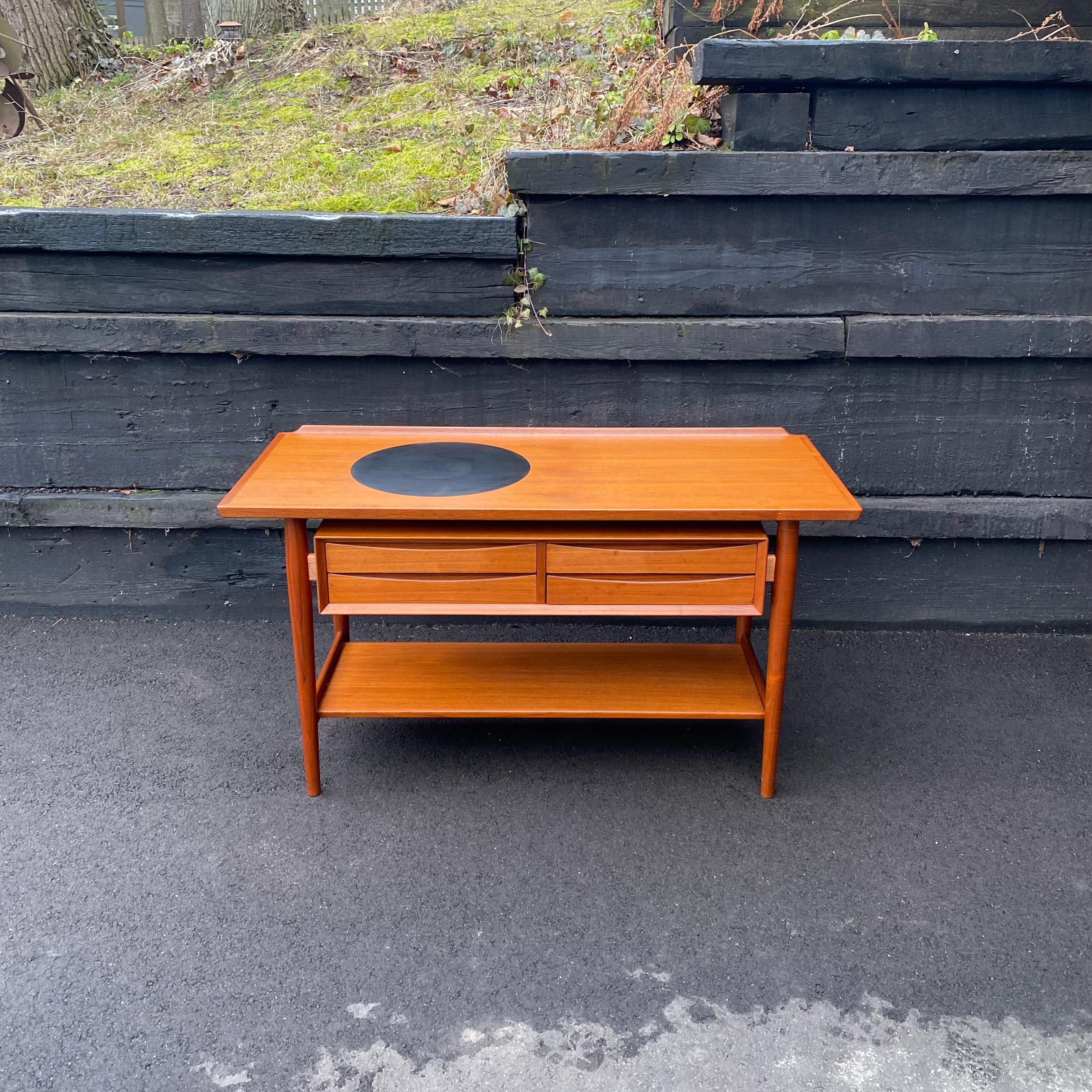 This is a stunning vintage teak server, buffet or sideboard designed by Arne Vodder for Sibast Furniture, ca. 1960. It's made of solid and high-quality veneer old-growth teak. I purchased this piece directly from a retired Army officer who was