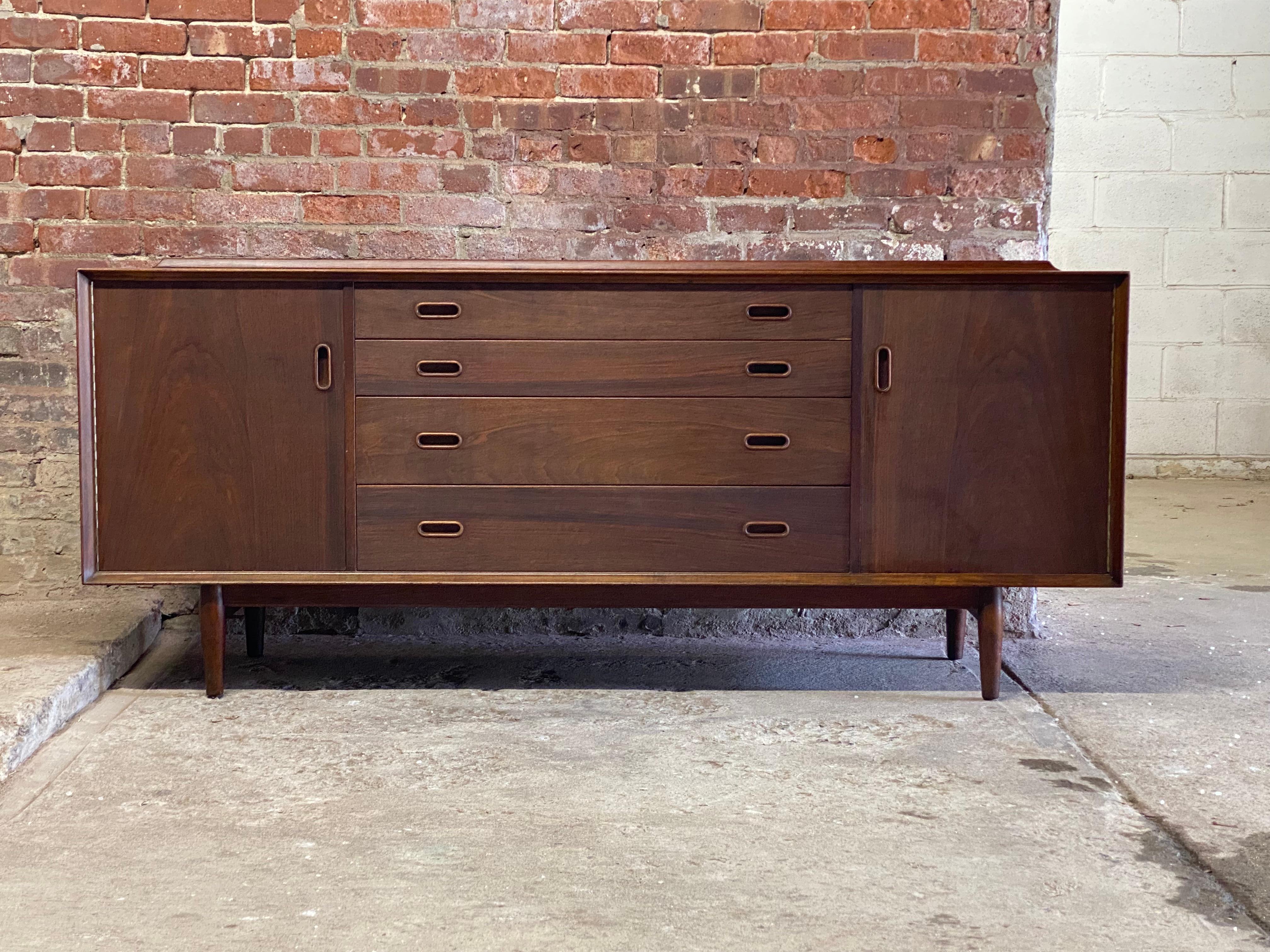 Arne Vodder for Sibast Mobler teak Triennale sideboard. Four drawers flanked by two doors with adjustable height interior shelves. The interior is maple or birch lined. The cabinet features beautifully figured teak veneers, recessed handles,