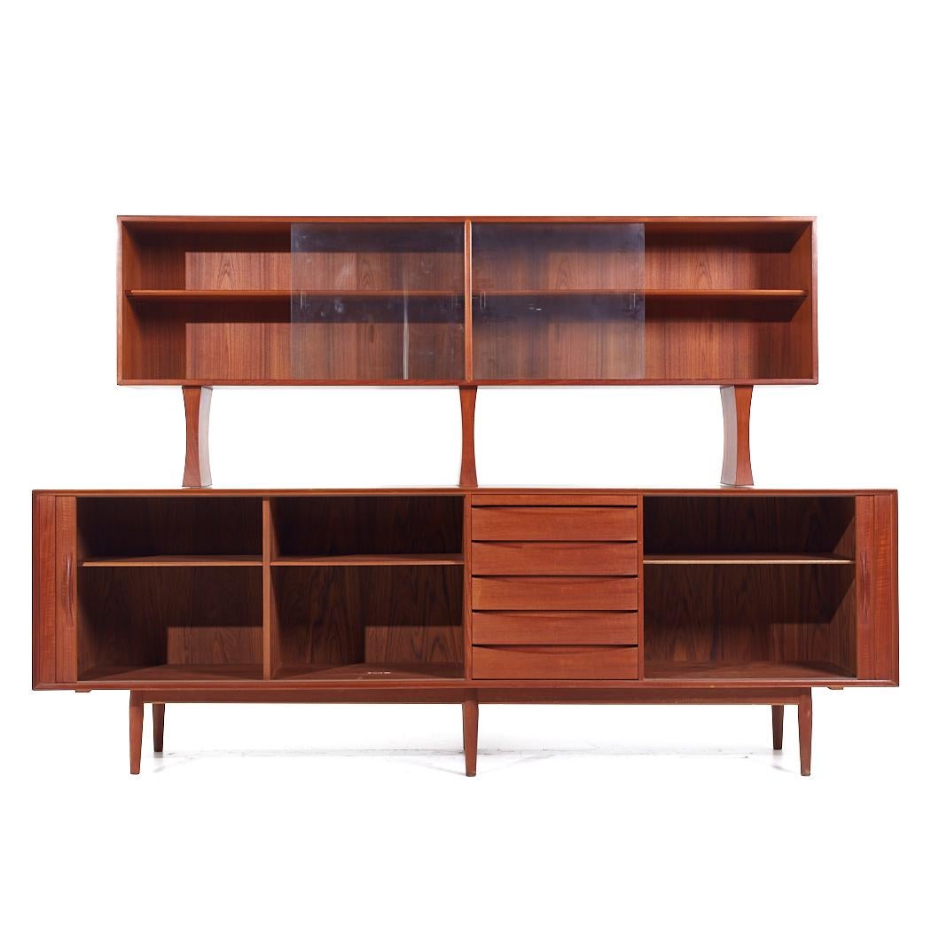 Arne Vodder for Sibast Model 76 Mid Century Danish Teak Tambour Door Credenza and Hutch

The credenza measures: 98.25 wide x 19.5 deep x 33.5 inches high
The hutch measures: 82.75 wide x 12.5 deep x 32 inches high
The combined height of the credenza