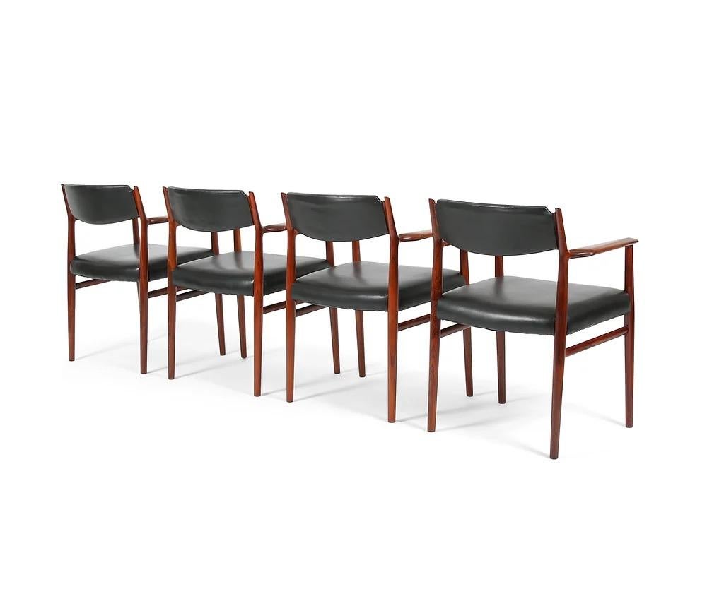 Here is a set of four Danish rosewood armchairs in black leather by Arne Vodder for P. Olsen Sibast (Sibast), circa 1960s. These could be used as dining chairs, but are large enough to be conference or desk chairs. The frames are solid rosewood and