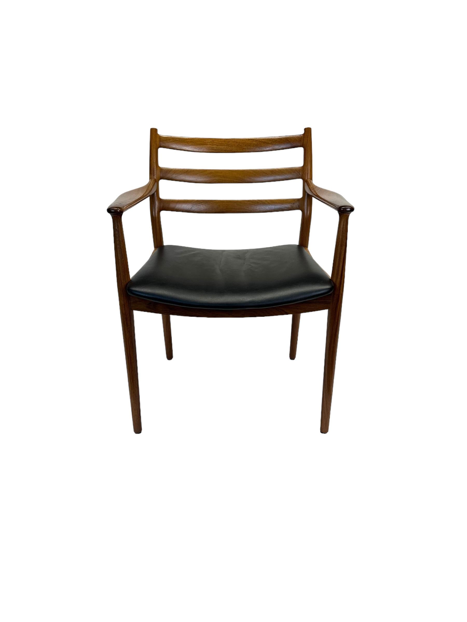 Beautiful solid rosewood ladder back armchair by Arne Vodder. An exemplar of understated yet carefully proportioned Danish modern elegance. In good condition, presenting well for age. Black leather tastefully tuned up but still matches the character