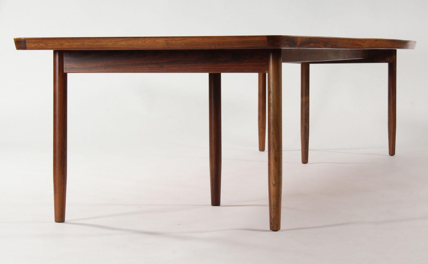 Mid-Century Modern extremely extremaly large rare Danish design dining table. We assume the table was designed by  Arne Vodder for Sibast during the 1960s.
The beautiful boat shaped top in combination with the familiar triangle frames legs makes