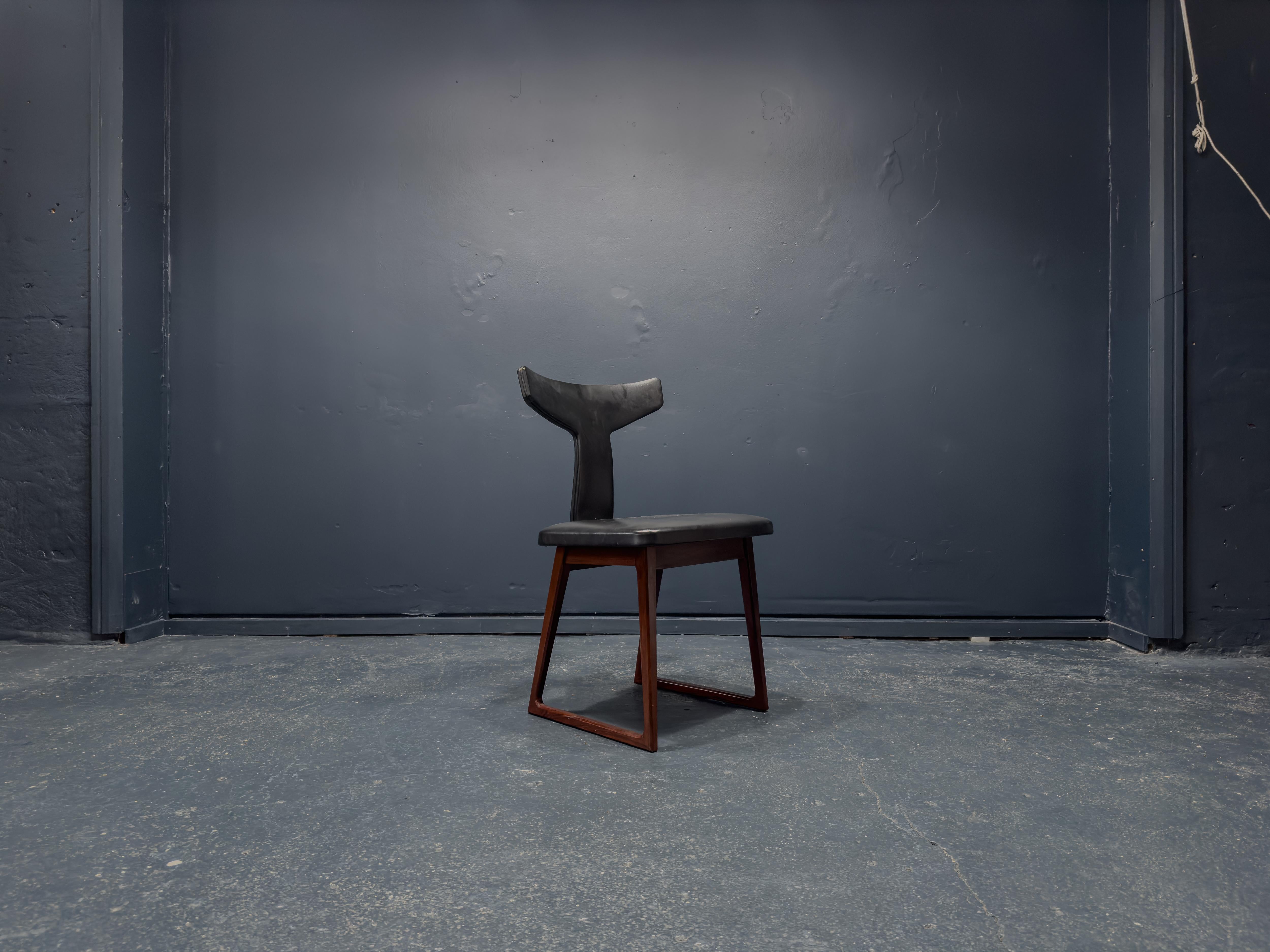 Created by Danish designer Arne Vodder in the 1960s for furniture manufacturer Sibast Furniture, this chair is a wonderfully unique piece. With a stunning hardwood frame and upholstered leather seat, the chair features gorgeous quality materials