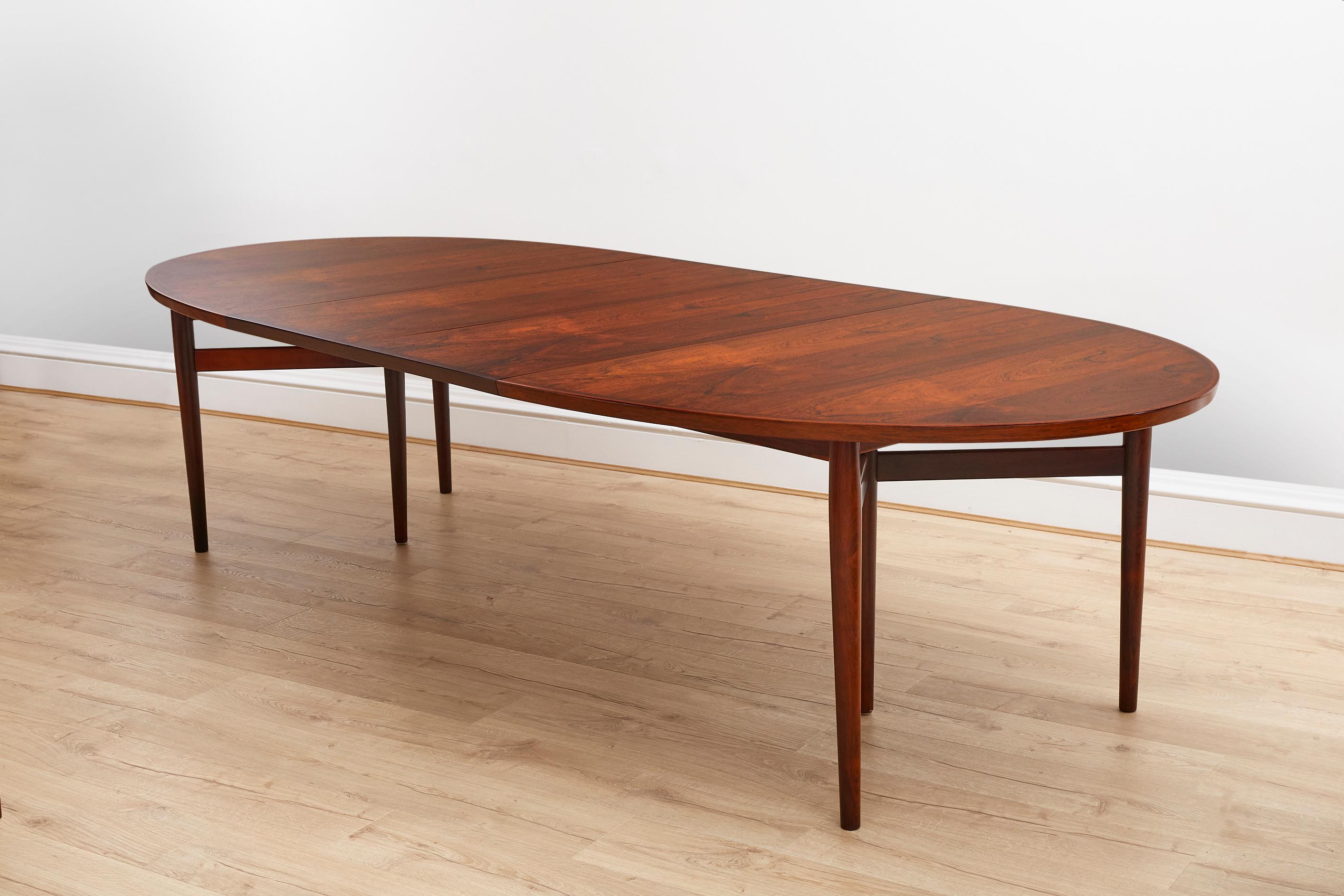 Designed by Arne Vodder for Sibast 1960's, Denmark.

 This Rosewood table is very versatile, with two leaves which can be applied / removed, the table is Ideal for a large room with interchangeable seating numbers. 

 